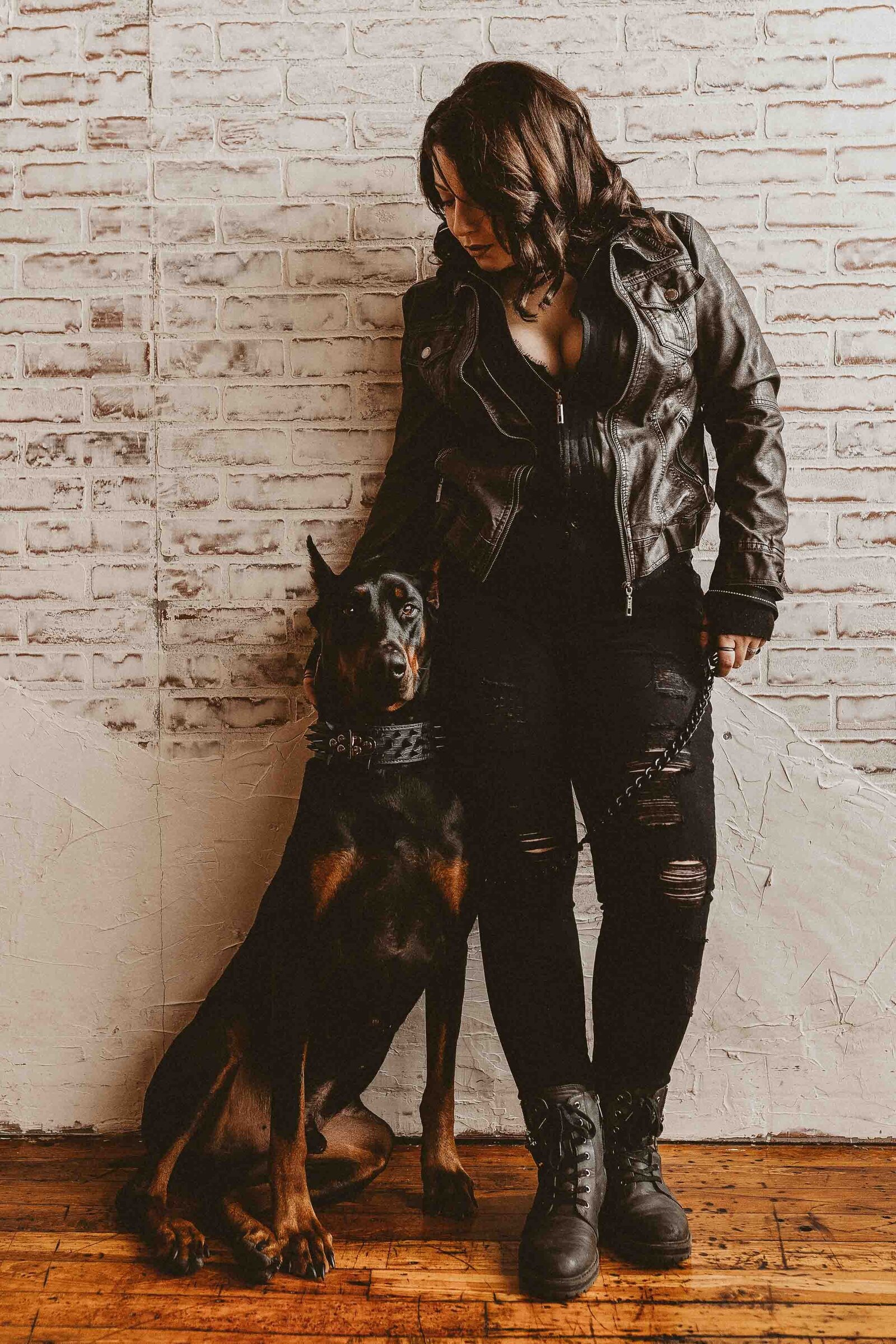 woman leaning on the wall with her dog