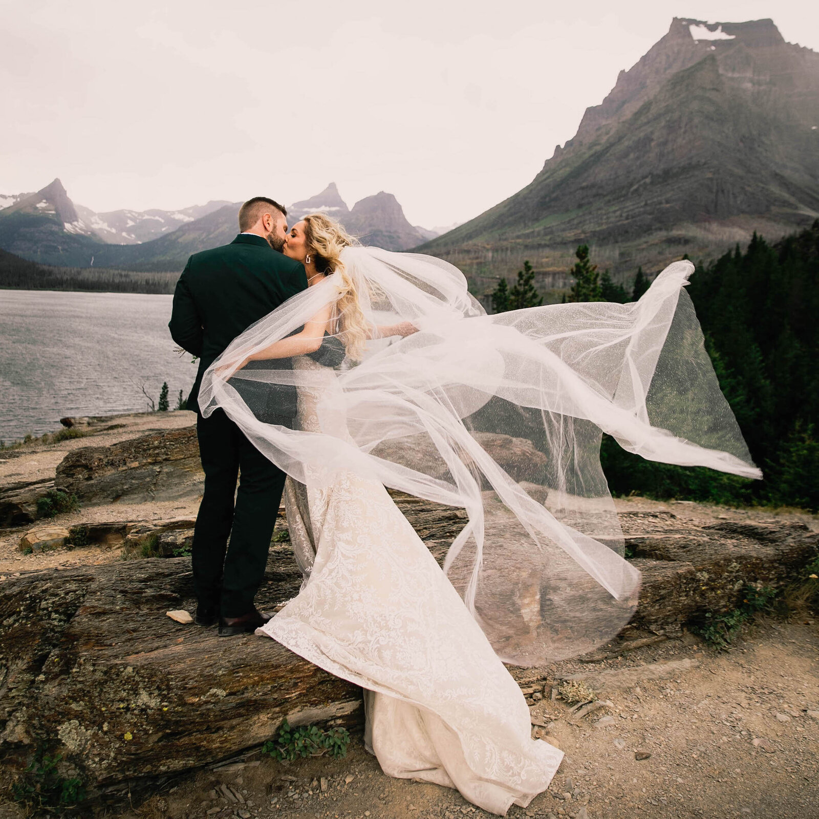 jennifer mooney photography - bride and groom embracing by mountain