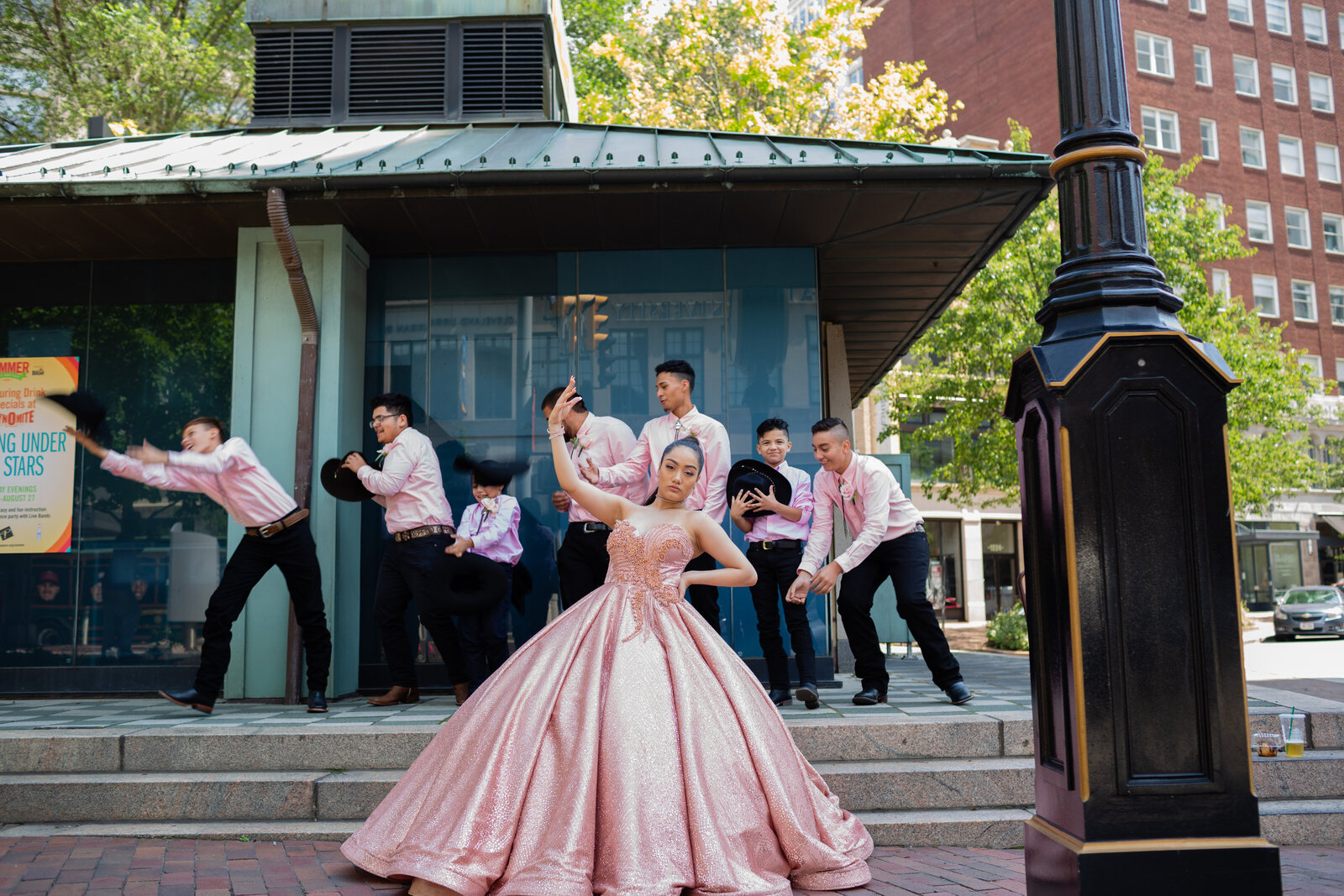 A lively group photo of the quinceañera with her chambelanes, captured at the iconic Playhouse Square in Cleveland, Ohio. Highlighting the charm and joy of this special celebration in a historic setting.