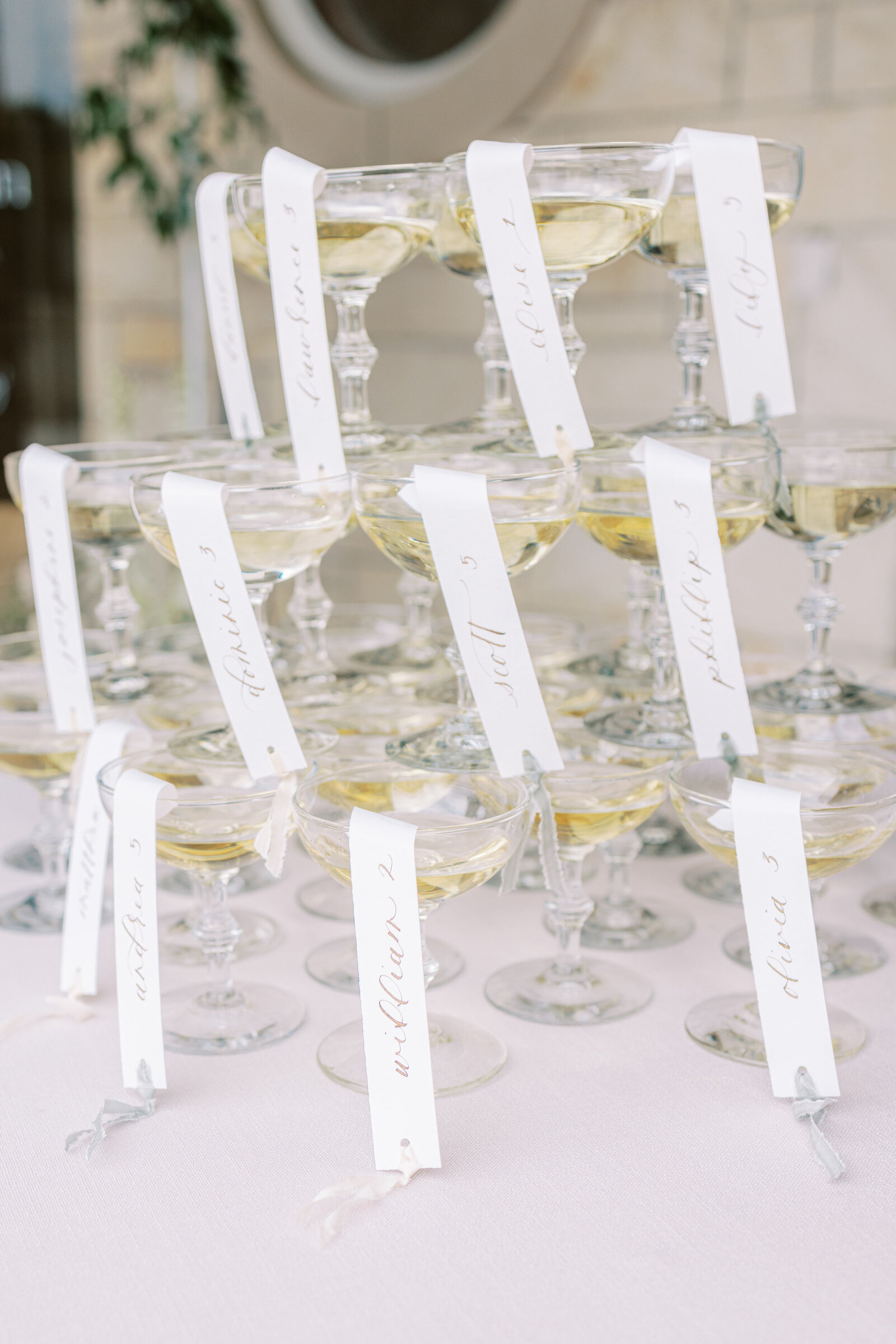 A champagne tower with place card settings at a wedding in Charleston, SC