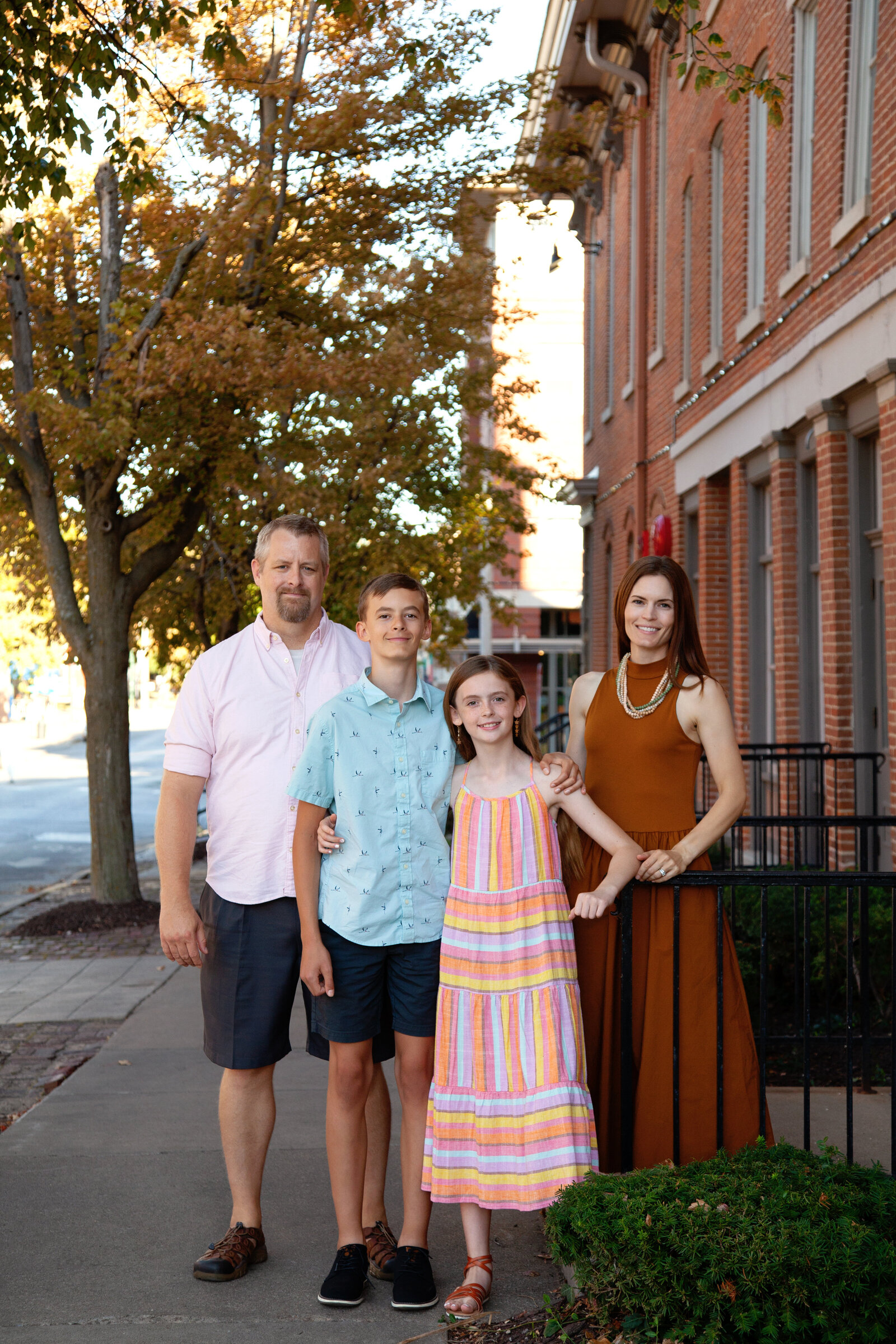 Family of four by brick building, Iowa City.