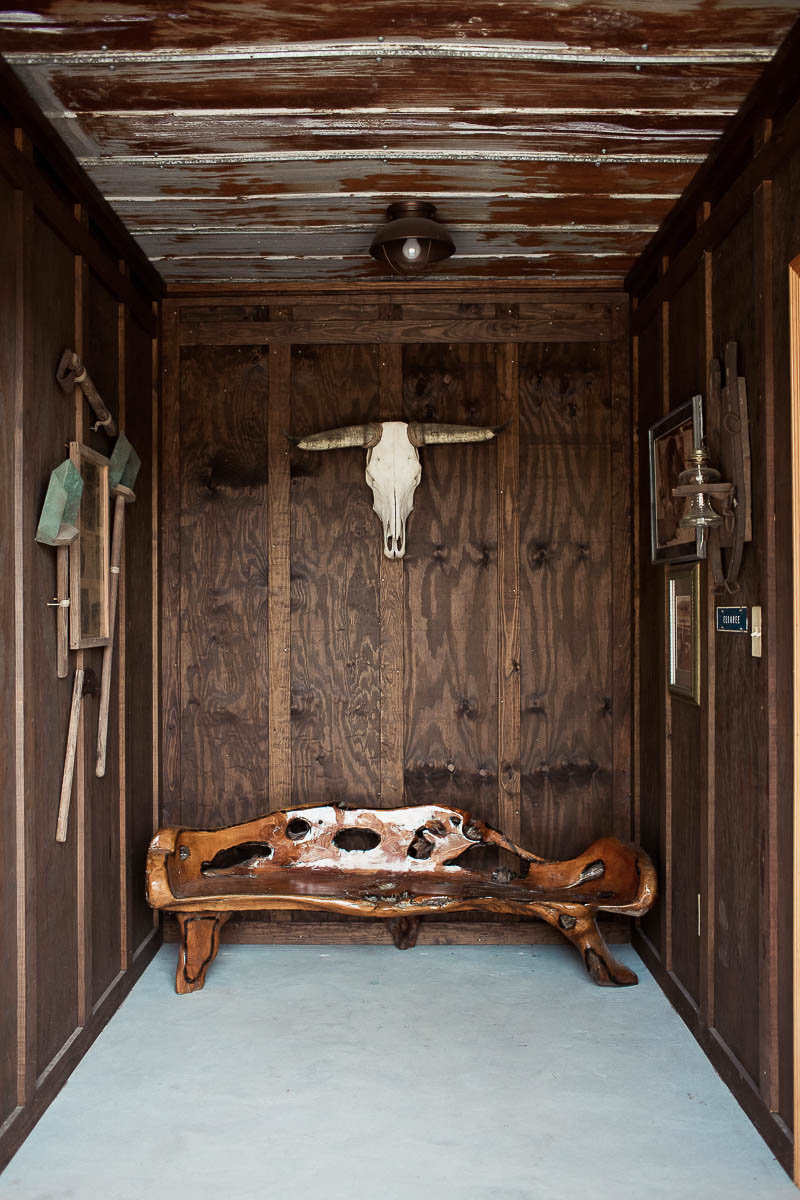 Unique wooden bench sits under bull head, Boals Farm, Charleston, South Carolina