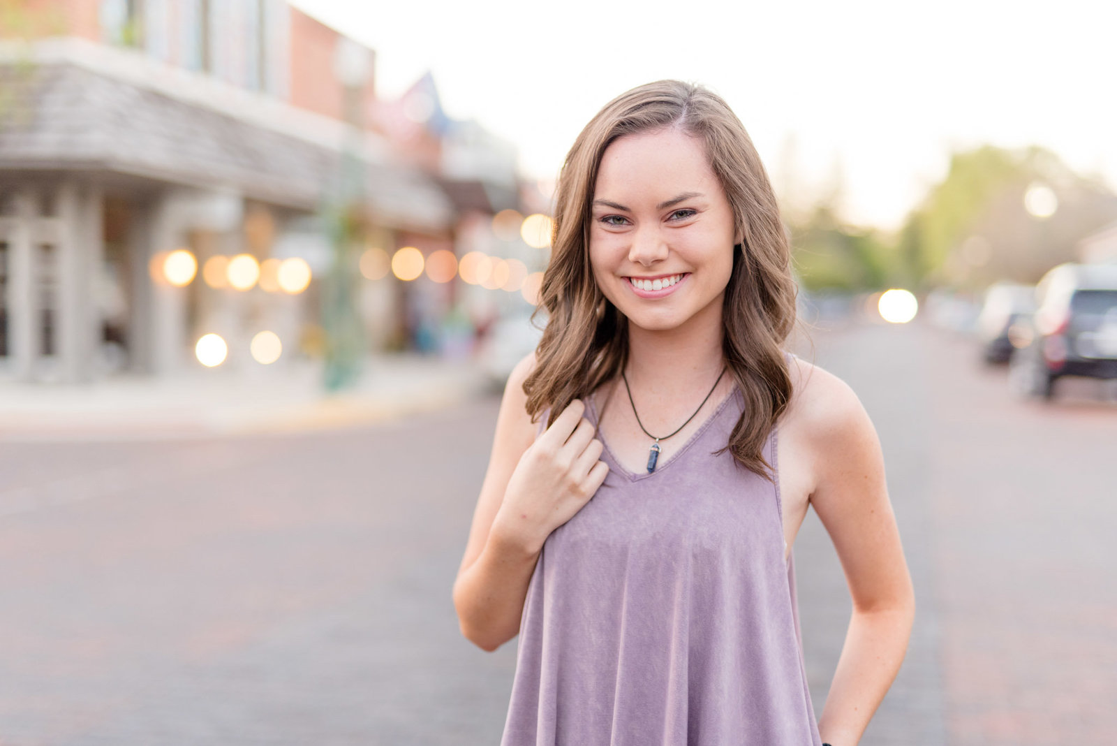 Senior smiles on brick road