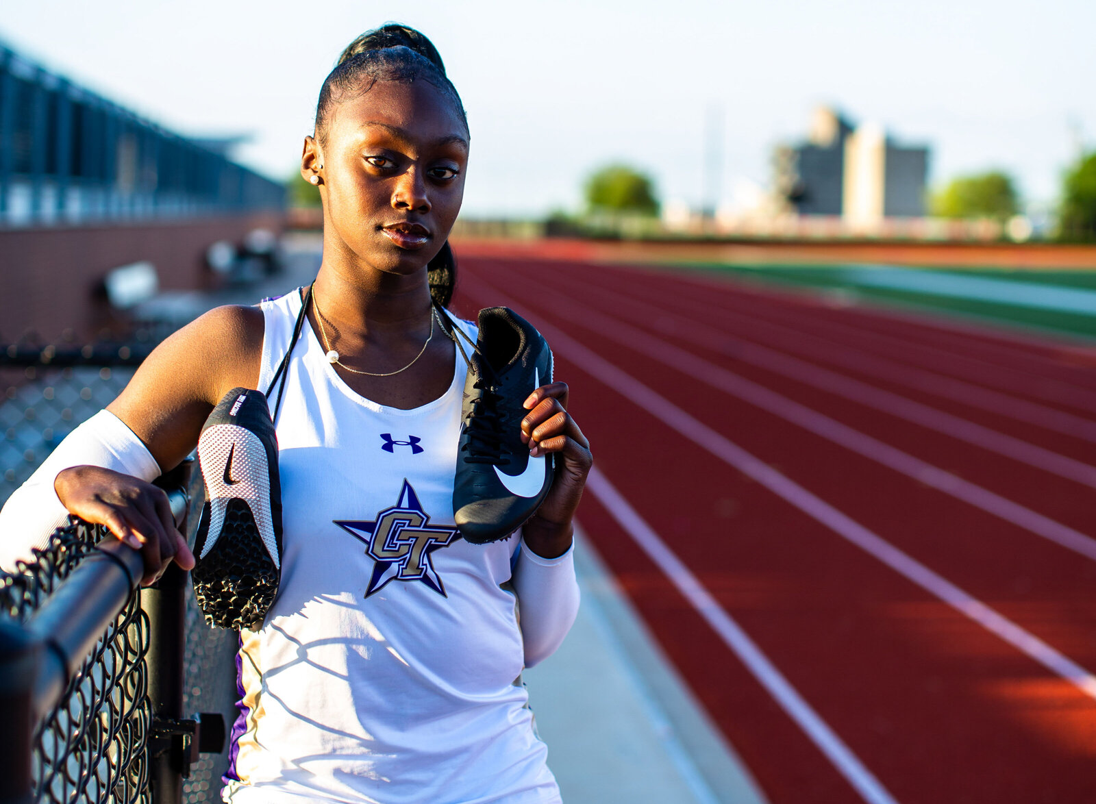 girl by track with cleats