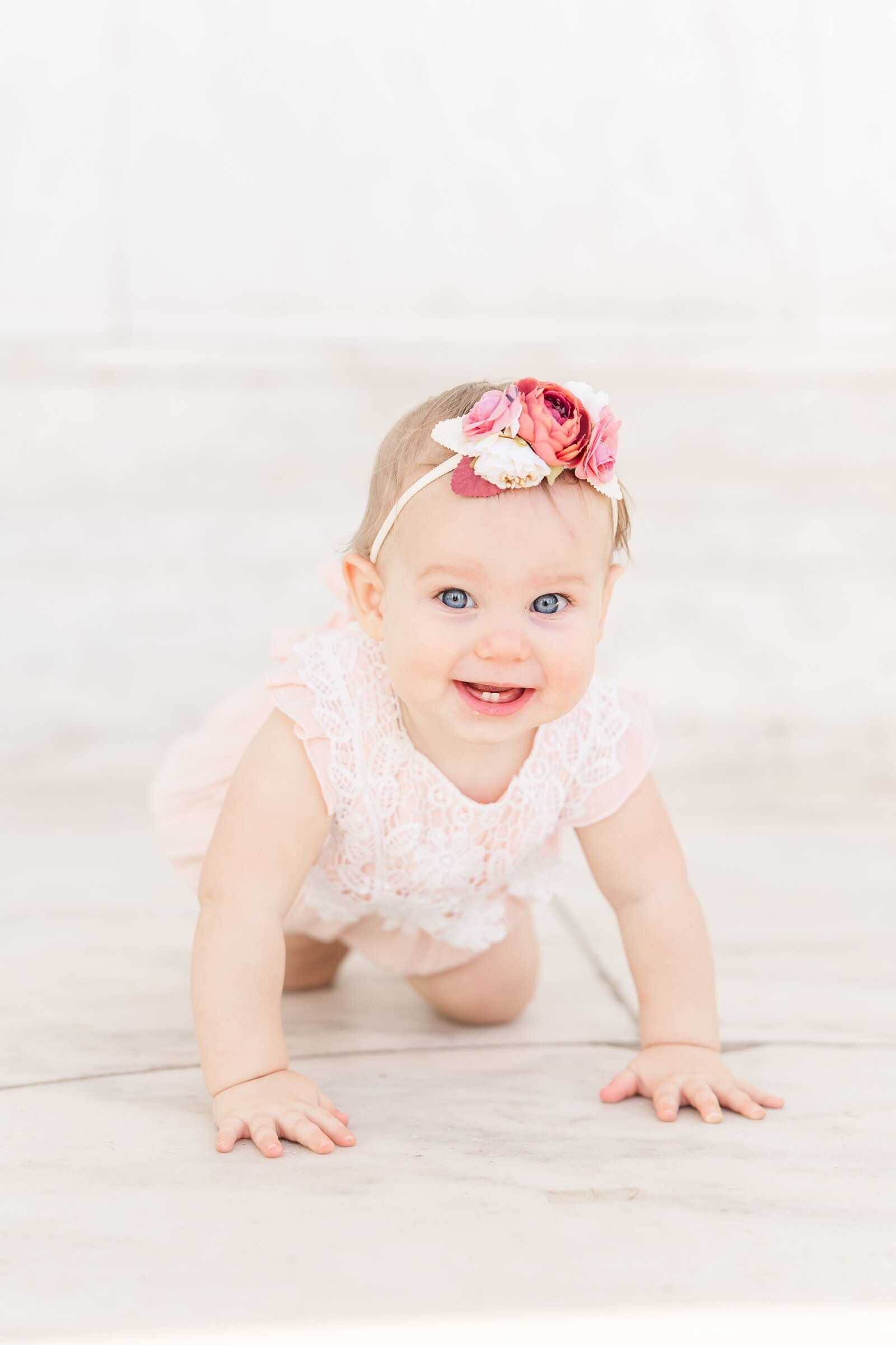 Little girl crawling towards Erin Thompson Photography