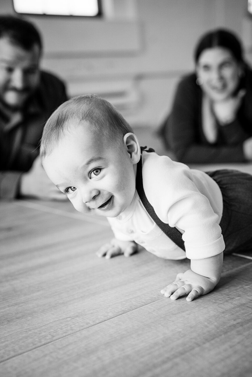 blck and white portrait of baby smiling at camera
