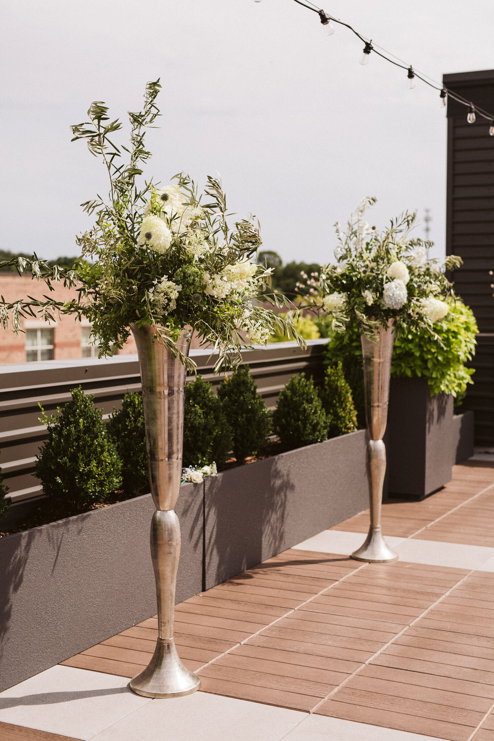 Tall floral vases on rooftop