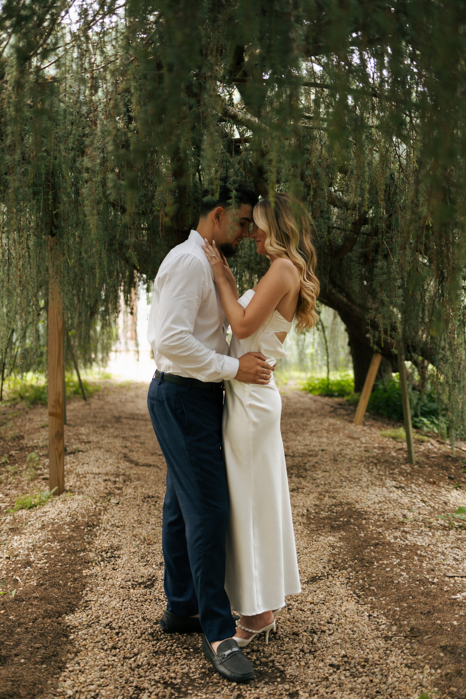Couple standing forehead to forehead under the weeping willows in New York | Emma LeeAnn Photography