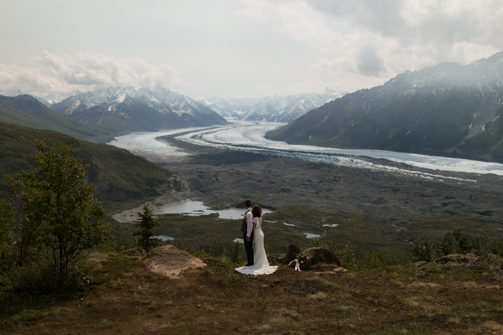 bride and groom looking at mountains