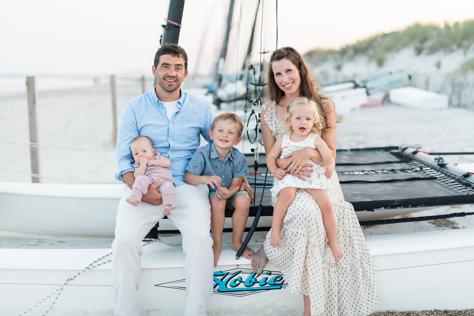 Pennsylvania family photographer, beach family photographer, family sitting on boat with kids