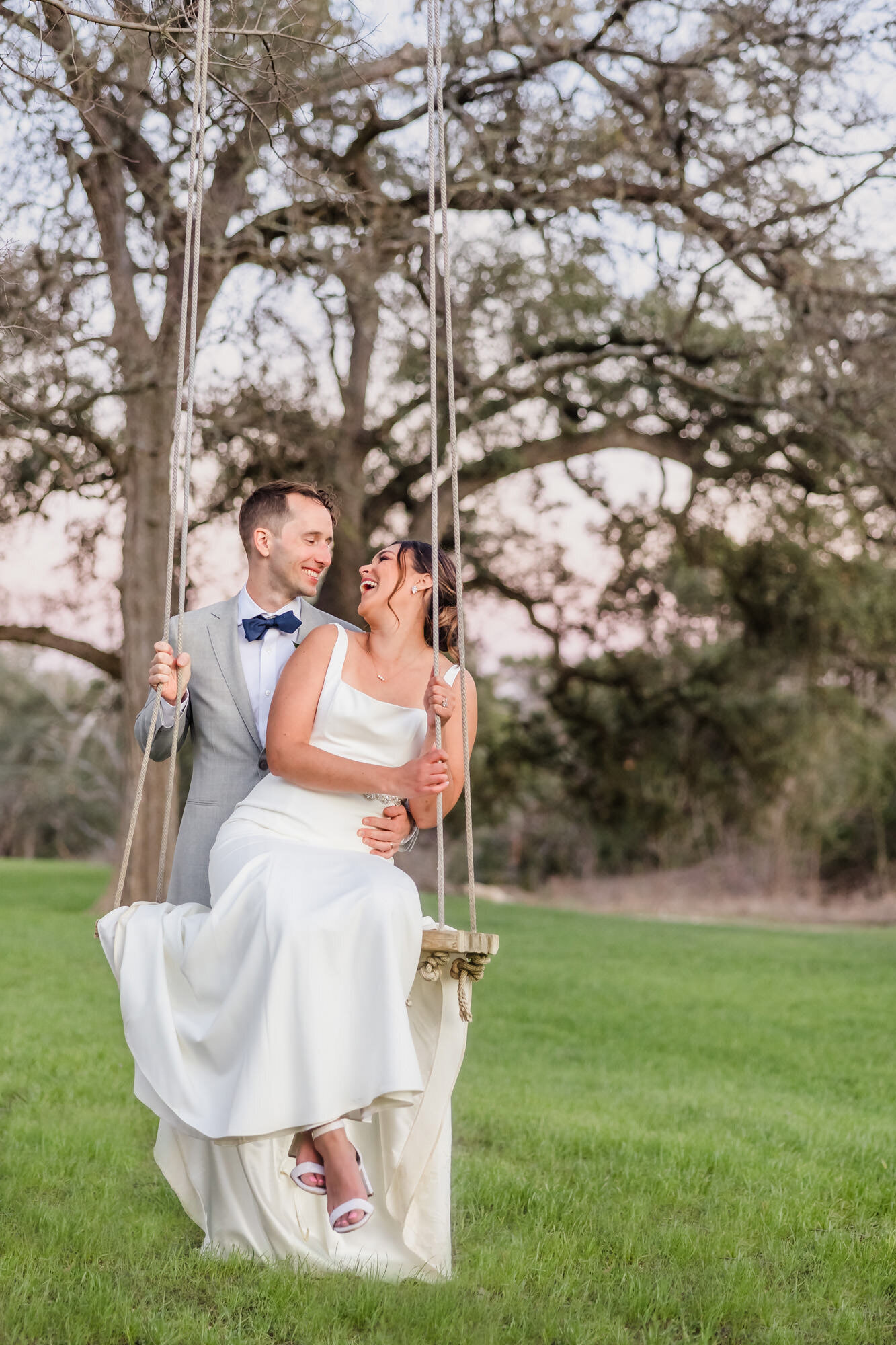Bride and Groom embrace at the Pecan Springs Ranch in Dripping Springs, Texas.