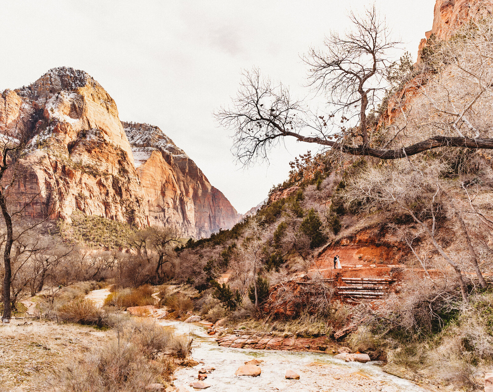 couple in the middle of the zion utah mountains