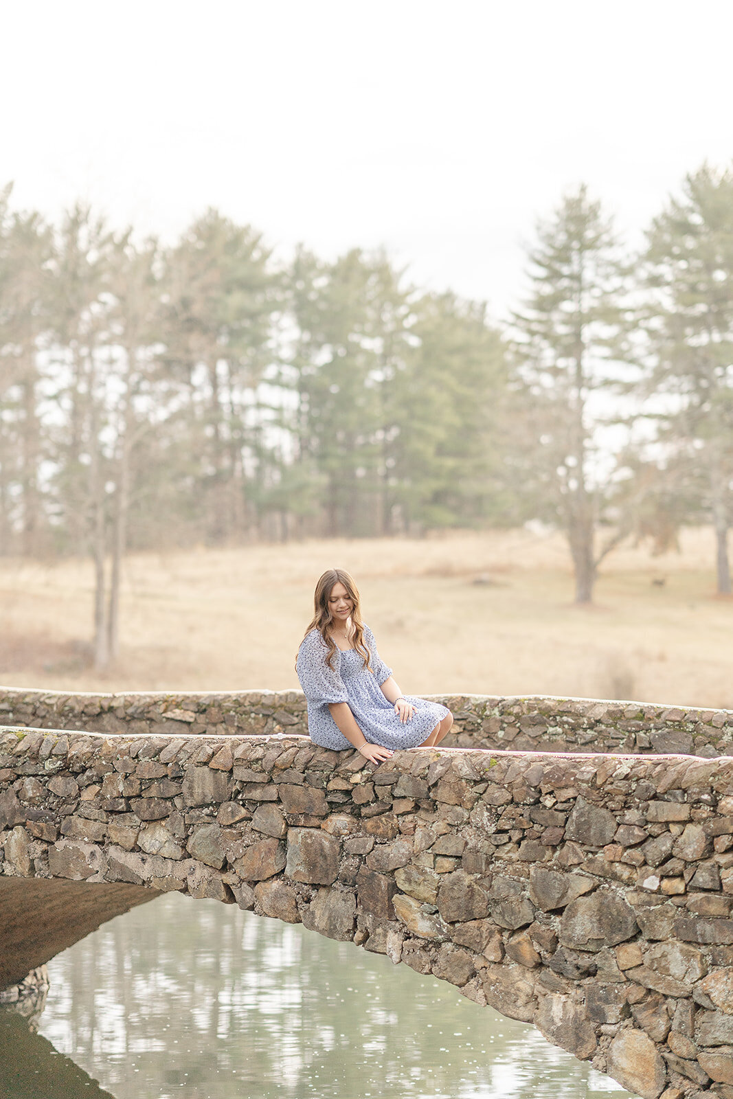 girl sitting on a  bridge during Warrenton, VA senior photo