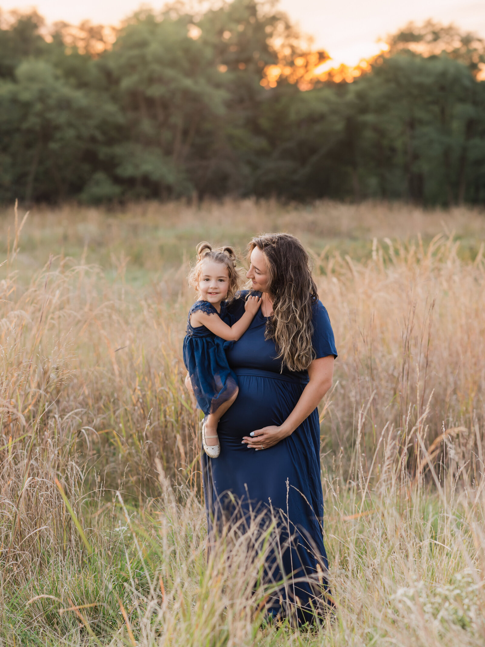 pregnant mother holding daughter for maternity photos cleveland maternity photographer