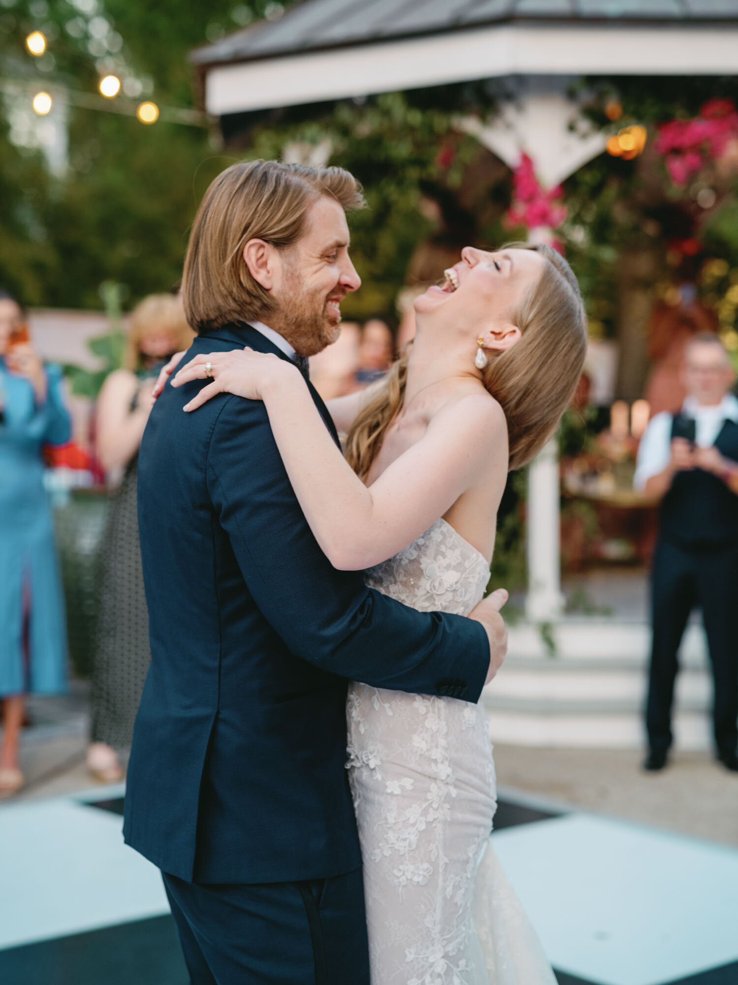 bride and groom laughing and dancing on dancefloor