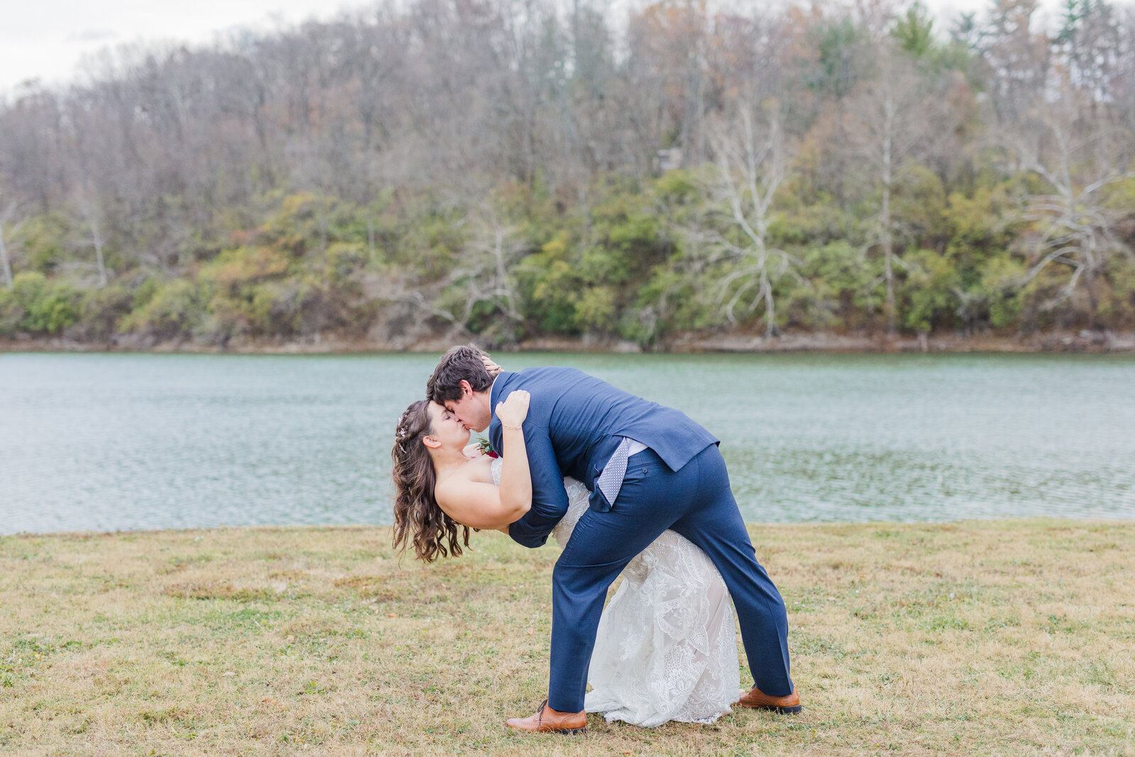 a groom dips his bride for a romantic kiss at Indie Hollow wedding venue
