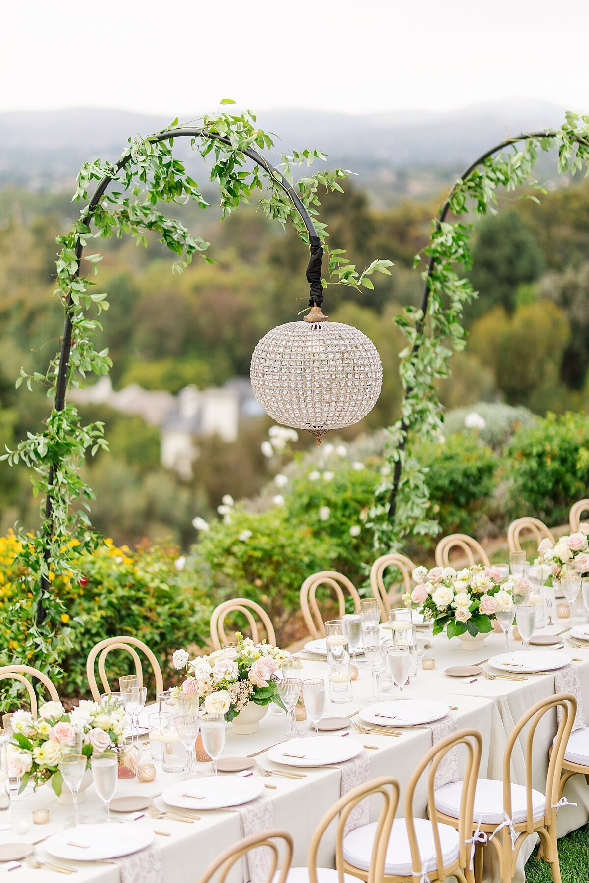 Crystal lantern hanging from ivy-covered stand at a private residence wedding in Rancho Santa Fe, California.