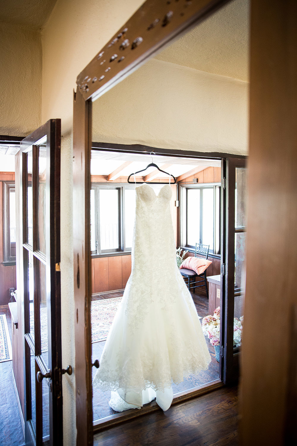 dress hanging on mirror in getting ready room