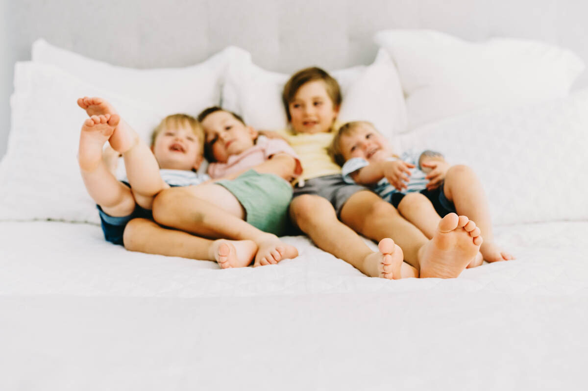 four brothers on a bed in their Bethesda, MD home