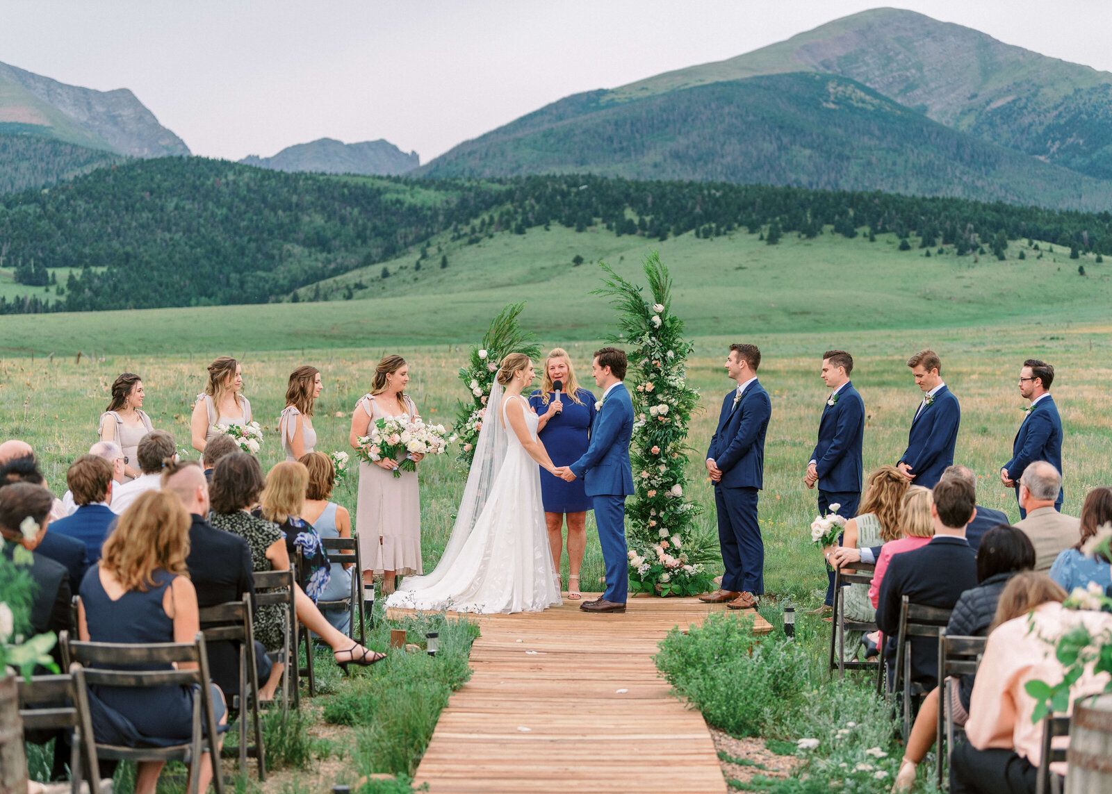 Emotional vows are shared during a wedding in front of a mountain