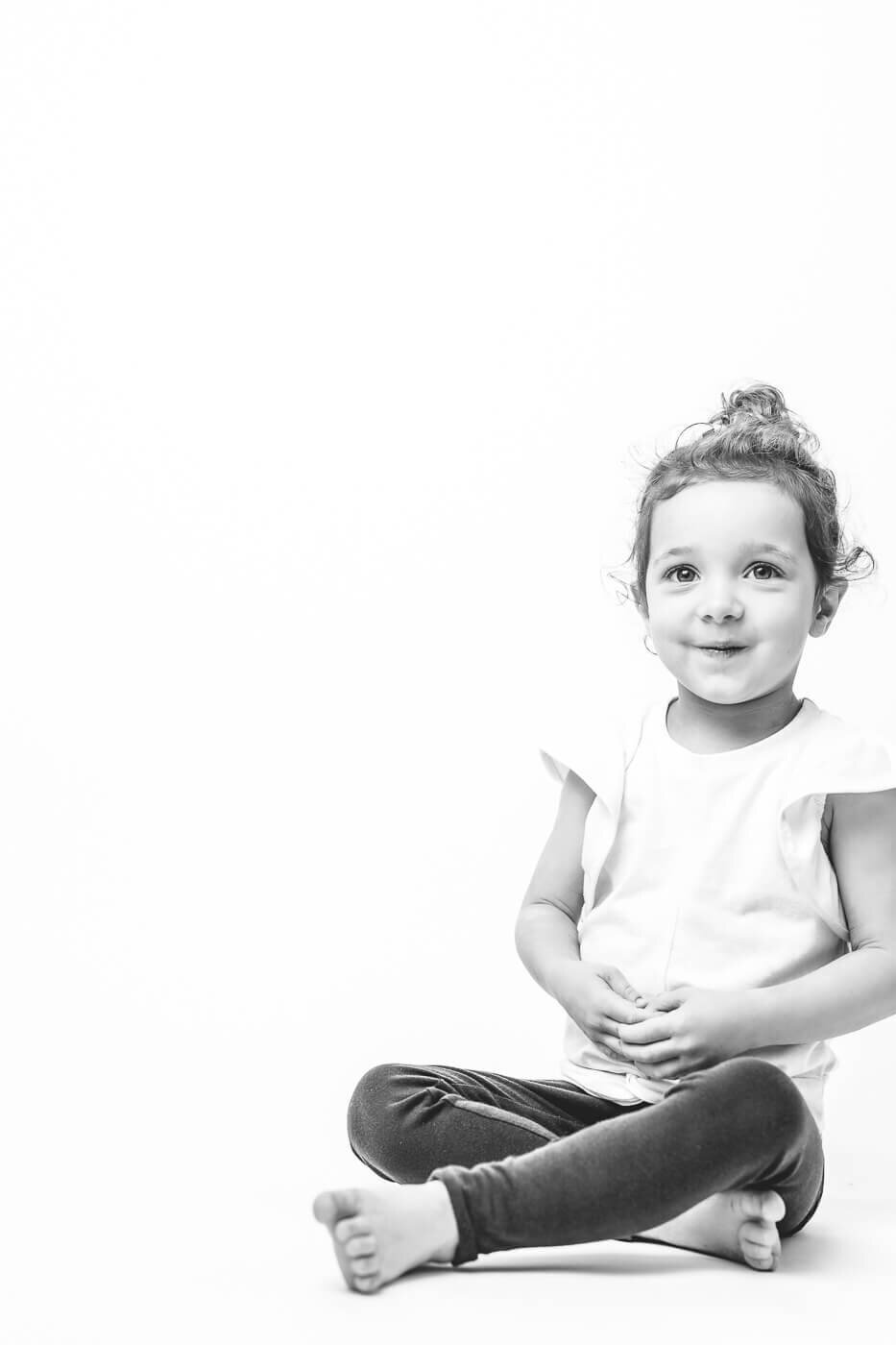 Childish girl, sitting crisscross applesauce for full body shot by Tampa photographer