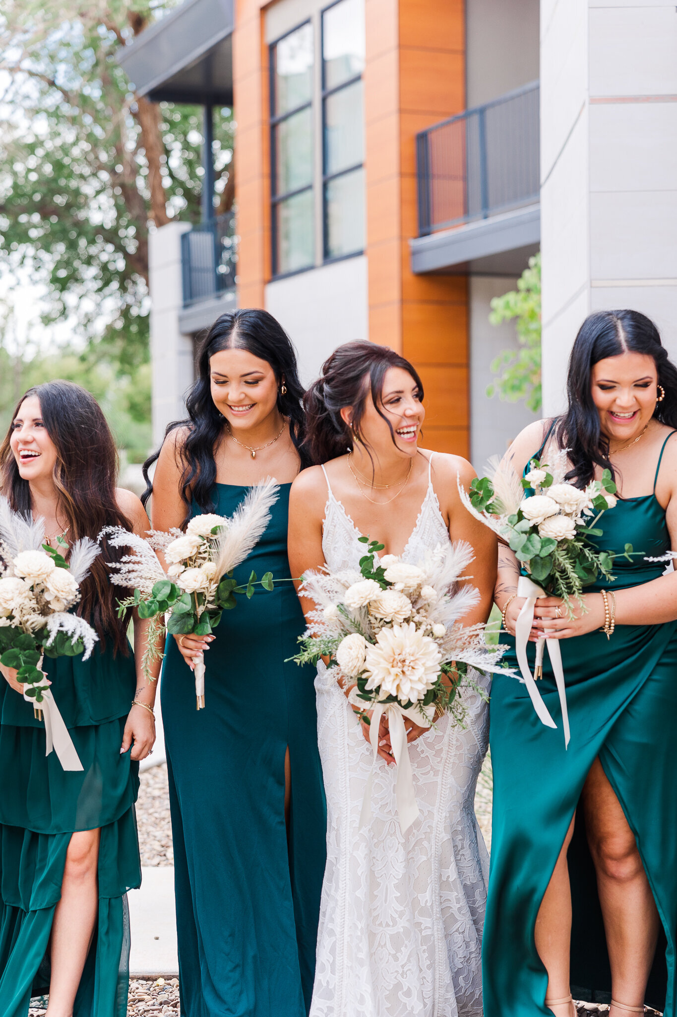 Bridemaids in emerald green dresses holding bouquets in Moab Utah