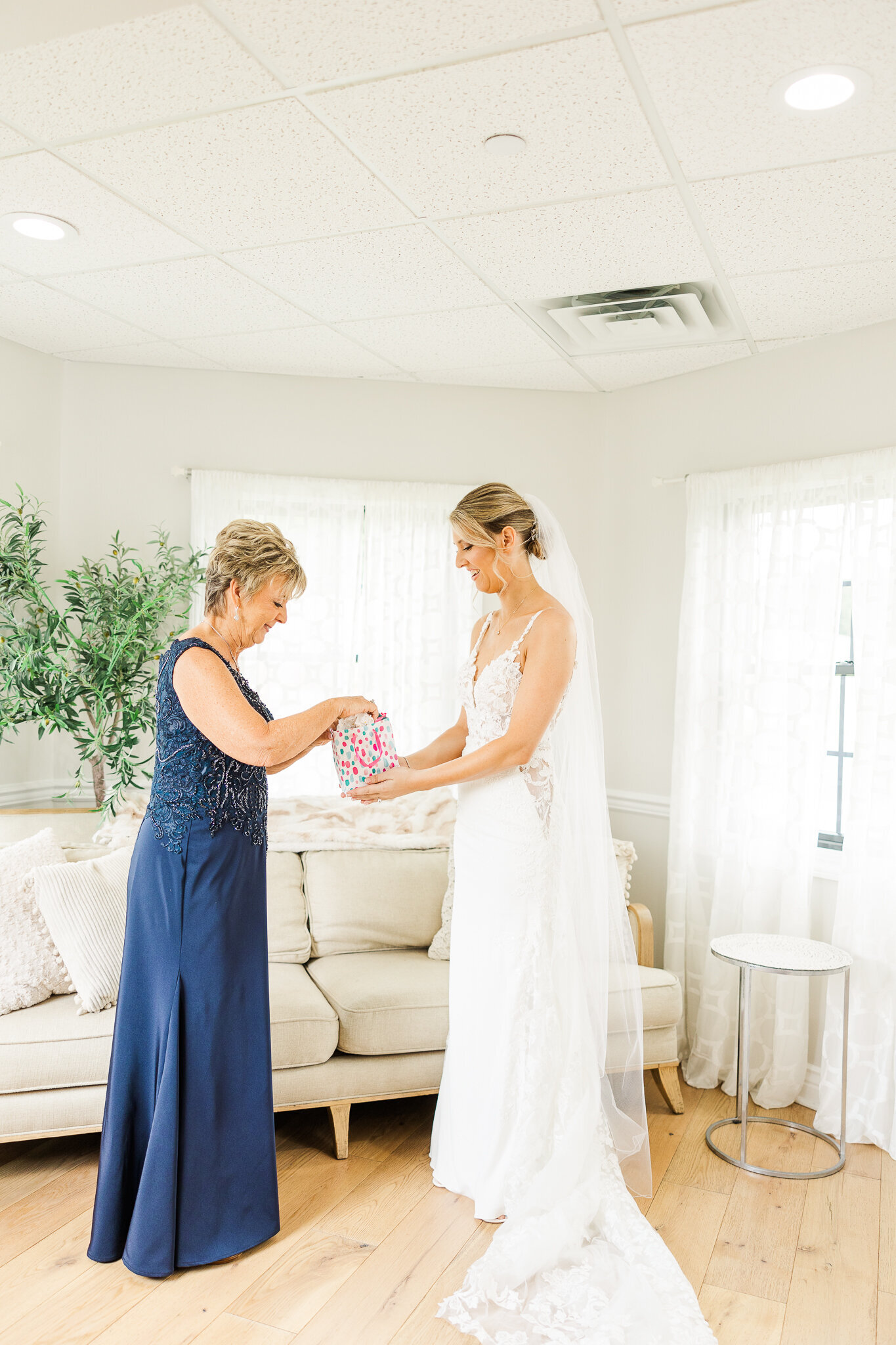 Bride handing a special gift to her mother before ceremony at SkyView Golf Club in Sparta, NJ