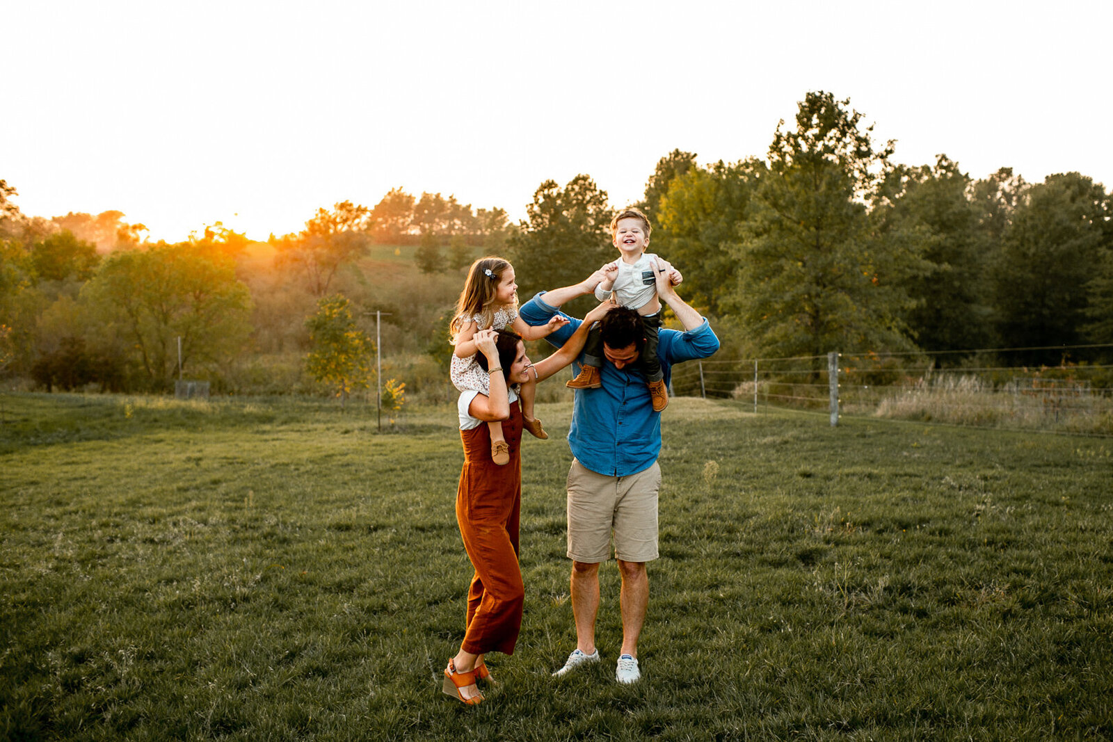 Des Moines family laughing and playing in open field