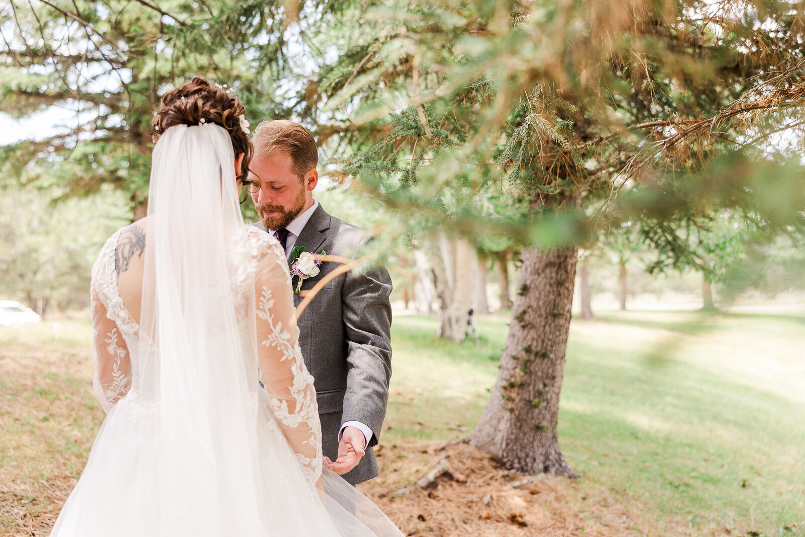 Emotional moment as the groom tears up while embracing his bride during their first look at a Ridgway State Park wedding.