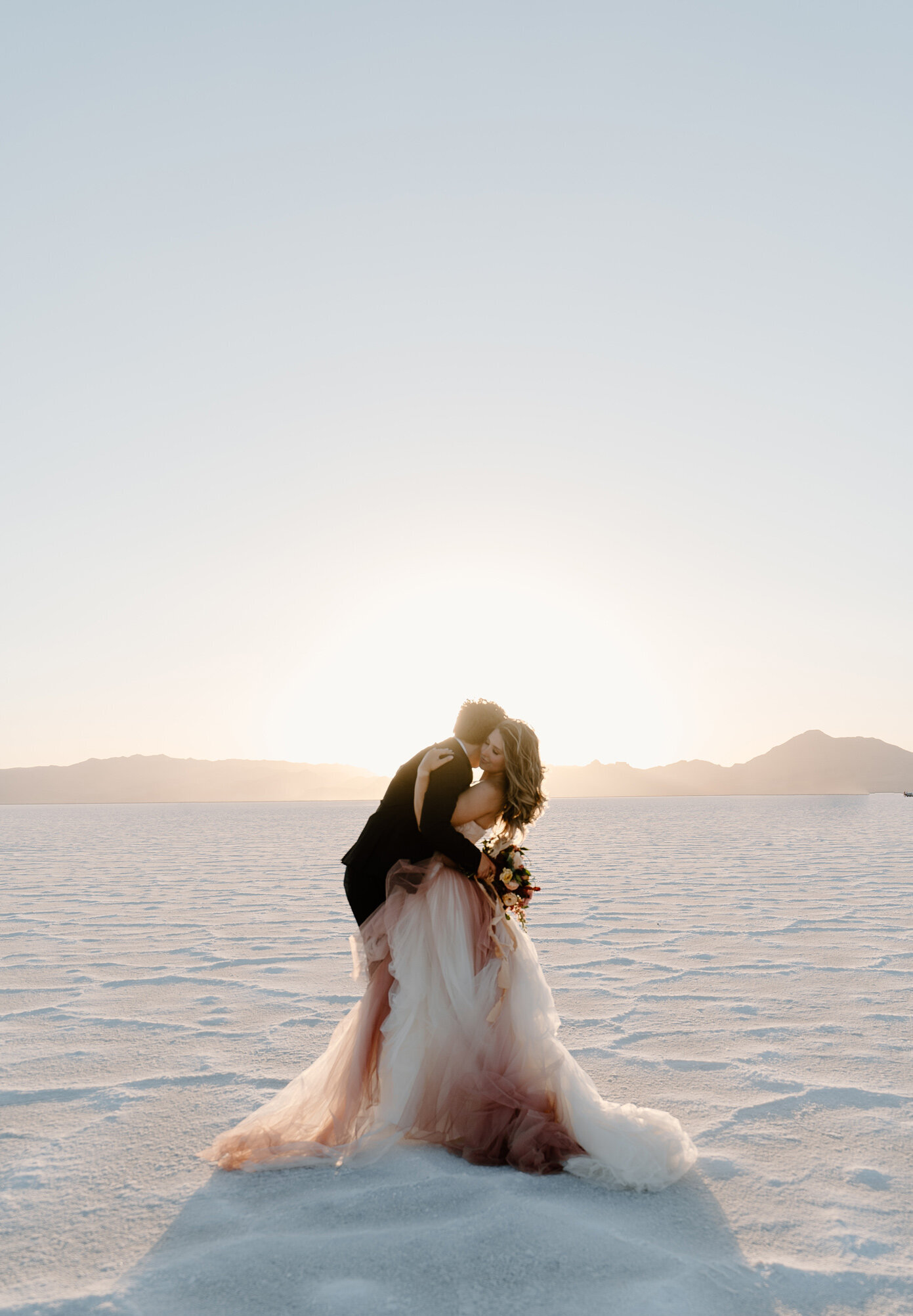 Beautiful sunset wedding photos of a couple in a Vera Wang dress at the Salt Flats in Salt Lake City, Utah
