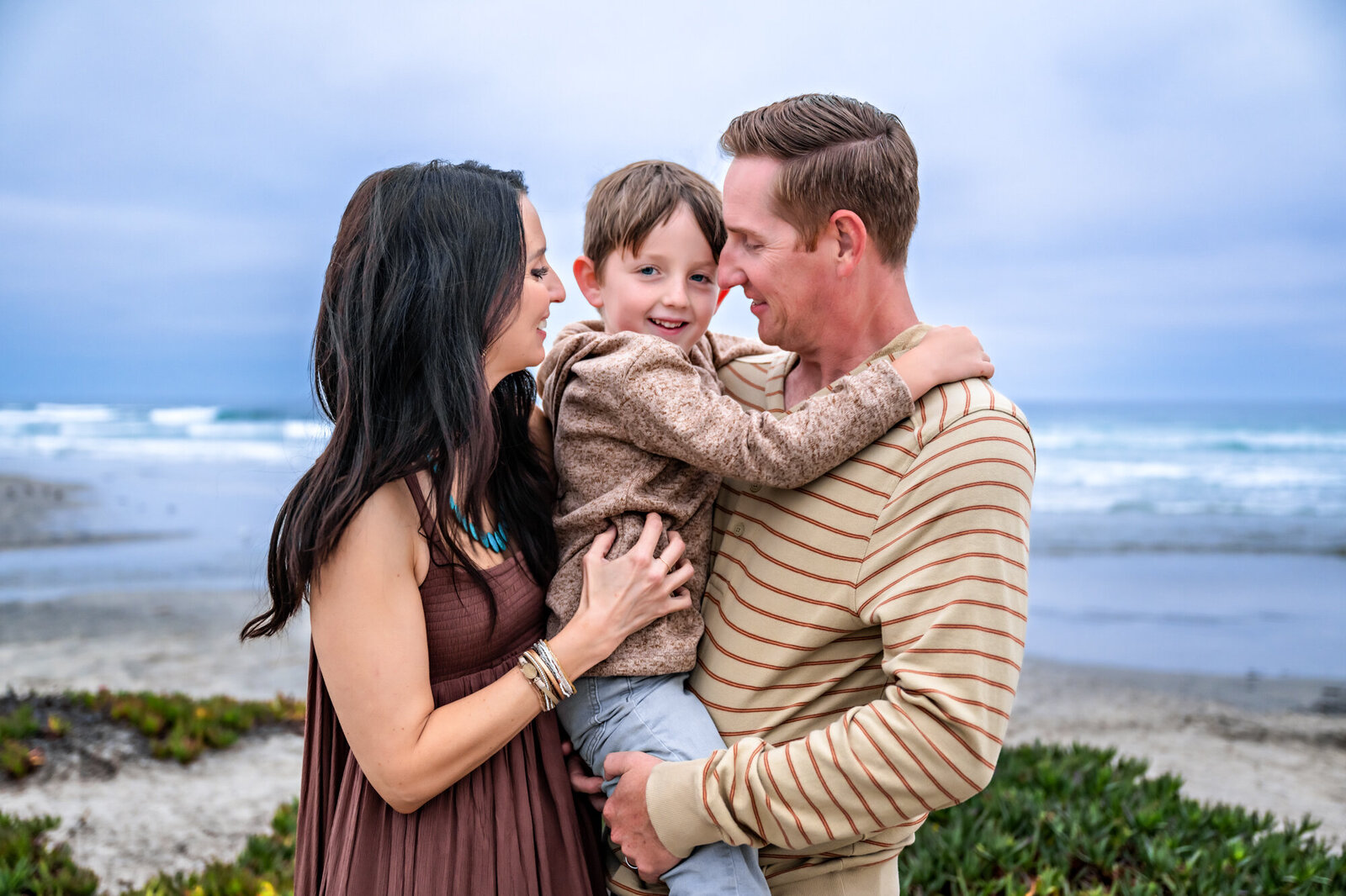 Family snuggles at beach photoshoot