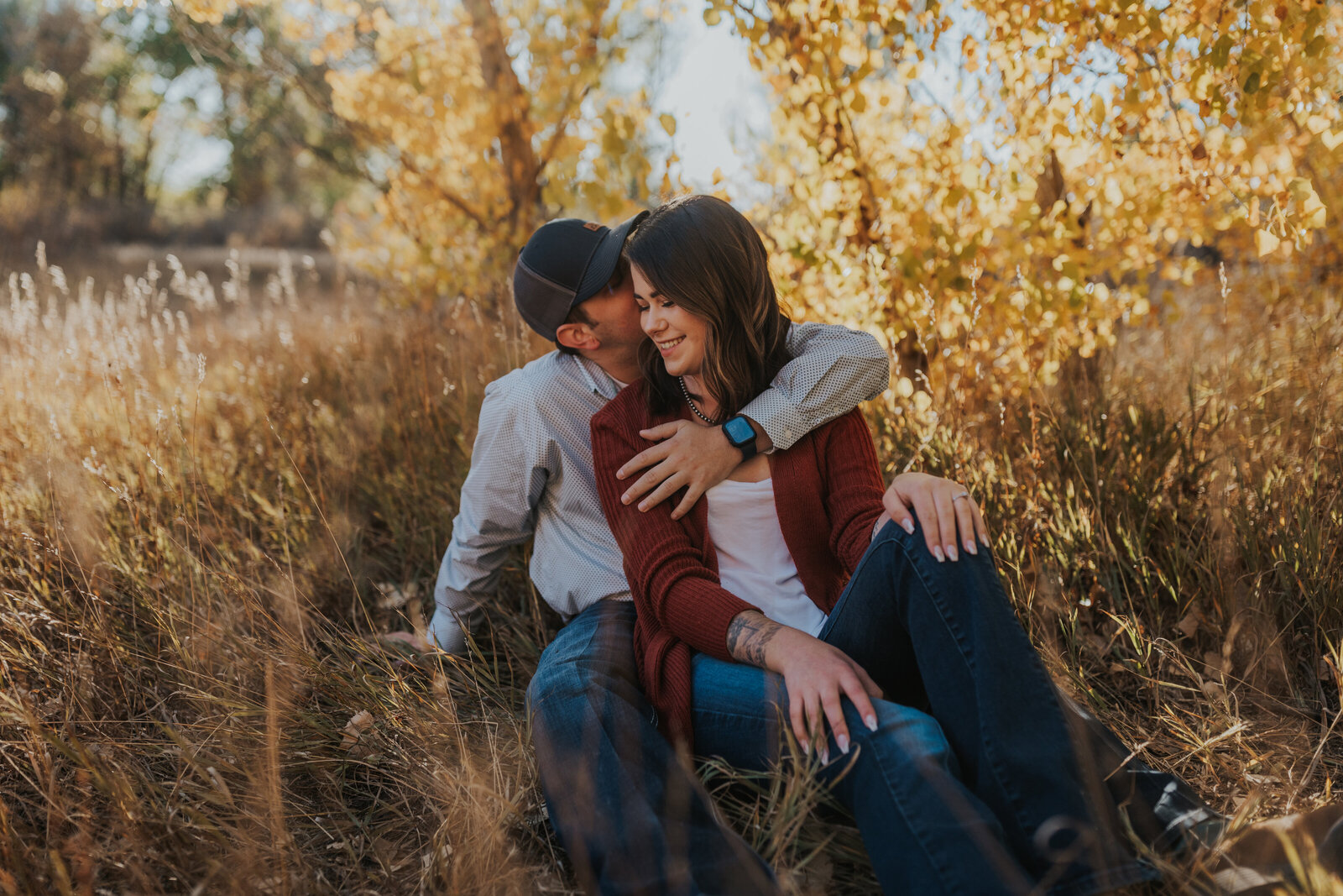 couple shares warm embrace in the colorado fall colors