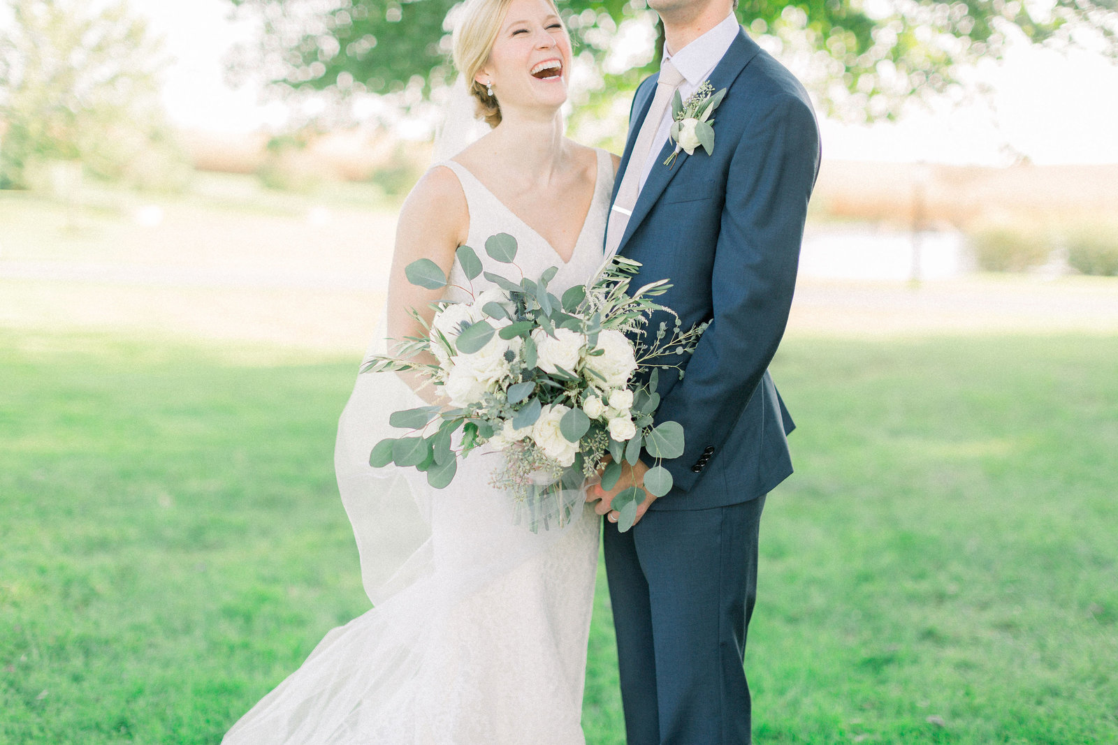 groom makes bride laugh during portraits at their lancaster farm wedding