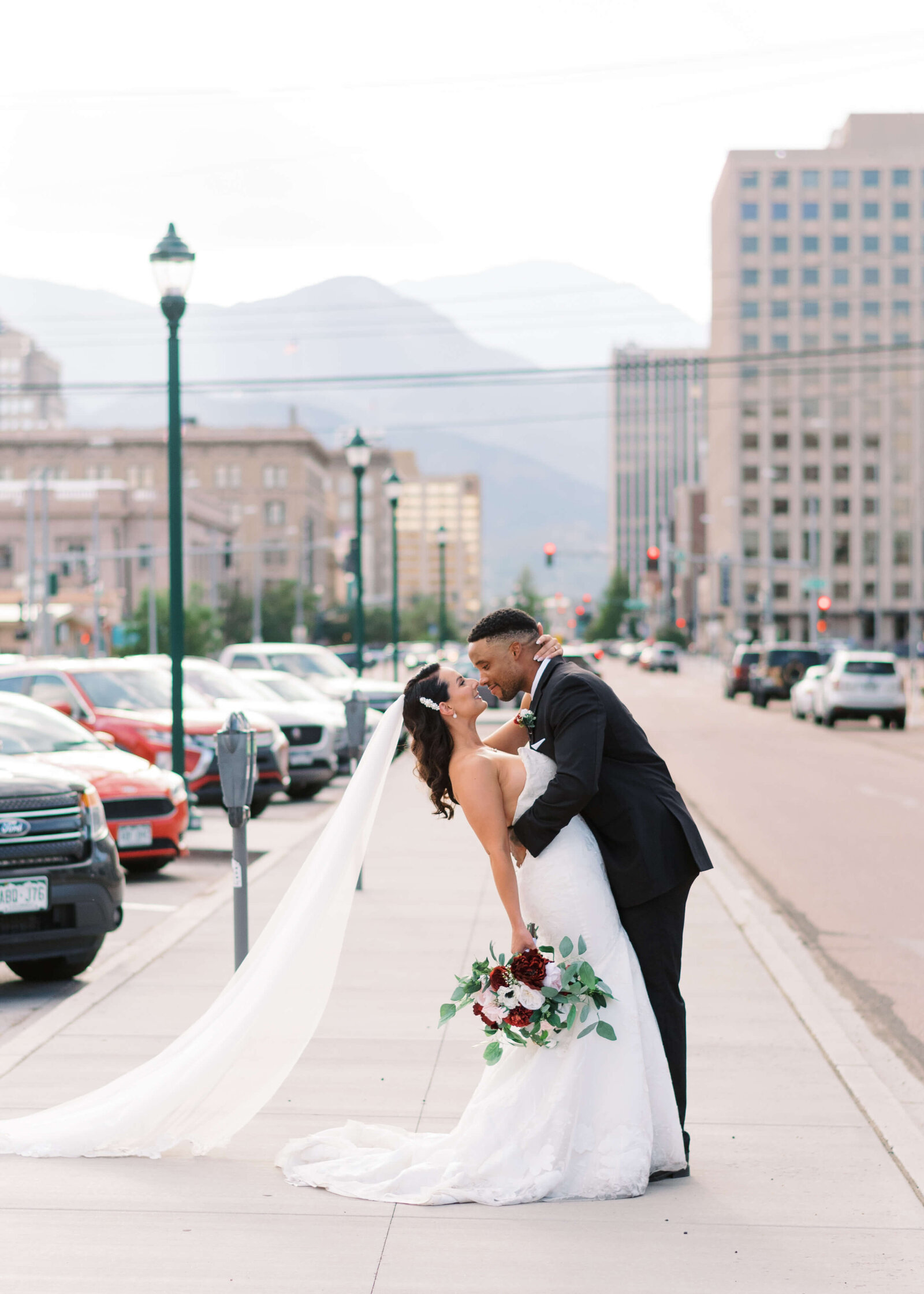 bride and groom kissing in downtown Colorad