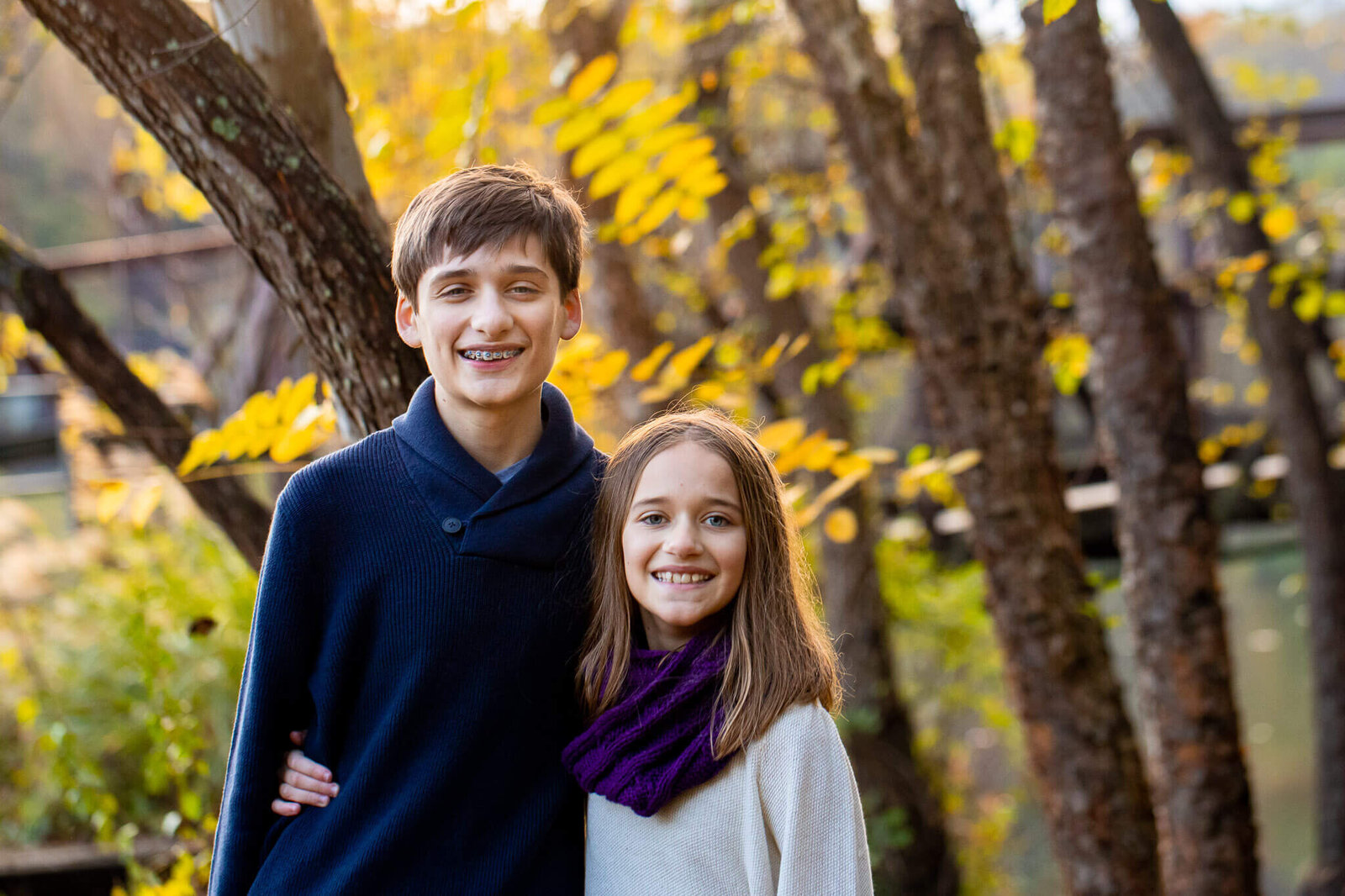 Siblings posing among the trees at Lake Accotink in Springfield, Virginia.