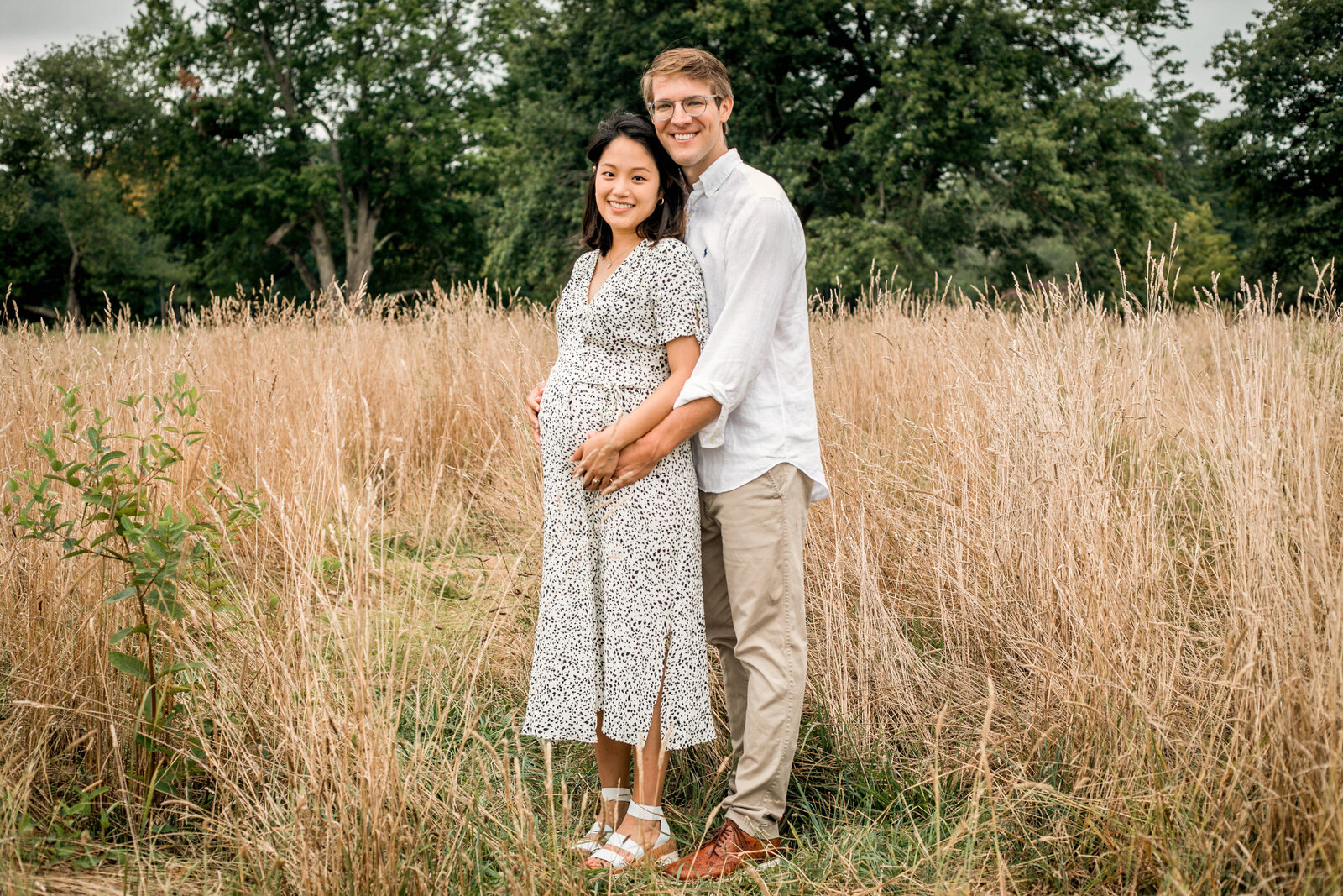 young couple holding hands and looking at the camera