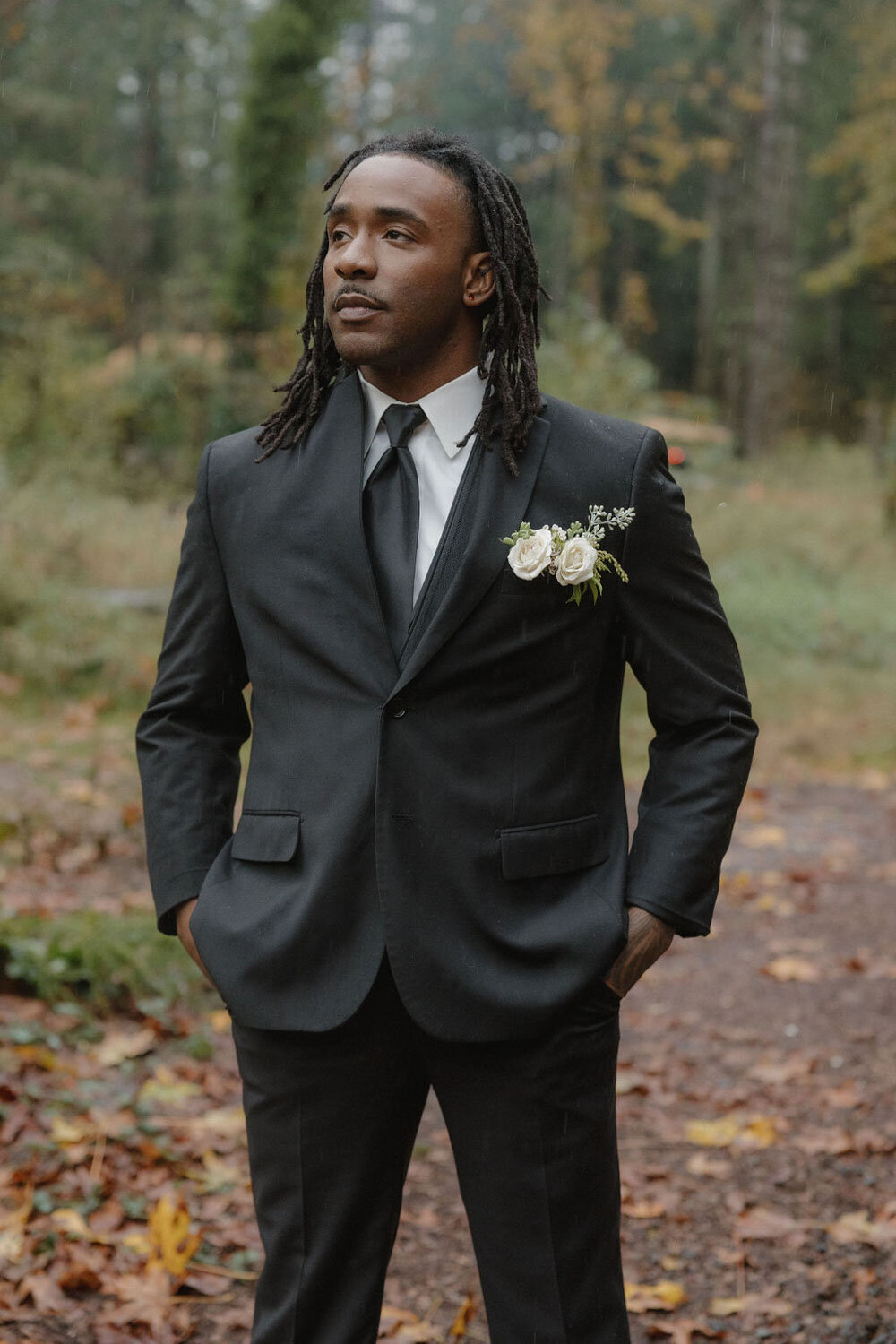 Groom standing alone outdoors