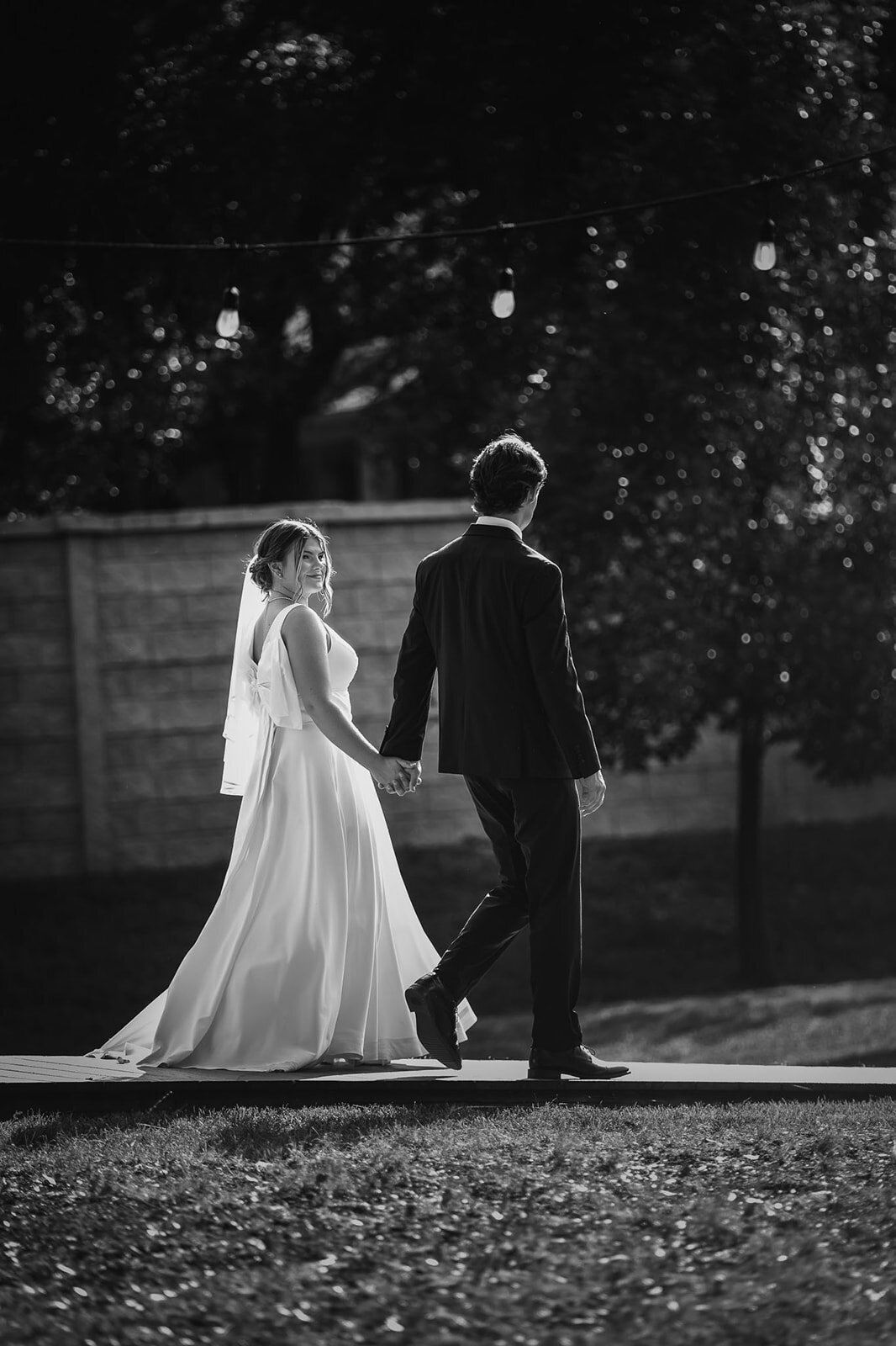 A timeless black and white photograph of a bride and groom at their wedding, captured by CMH Studios in San Antonio.
