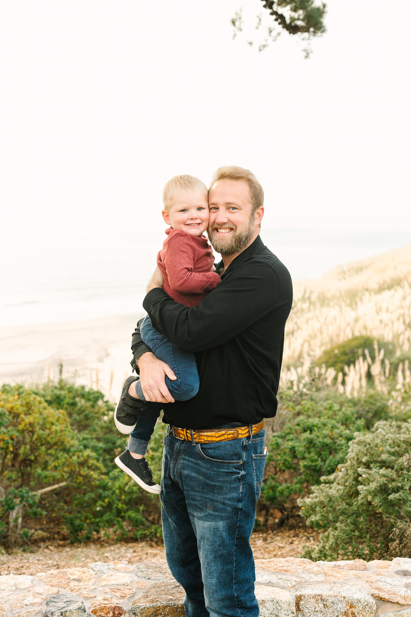A family poses for photos along the beach in Santa Cruz, Ca.