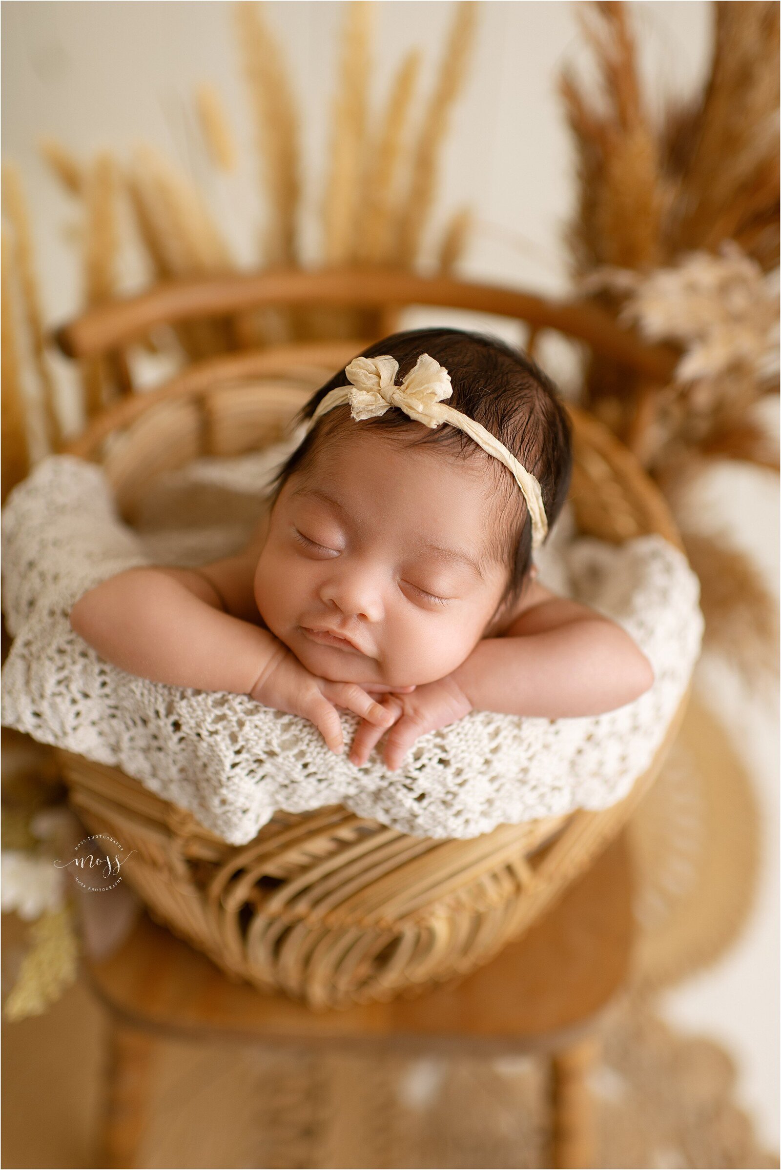 newborn baby in boho basket