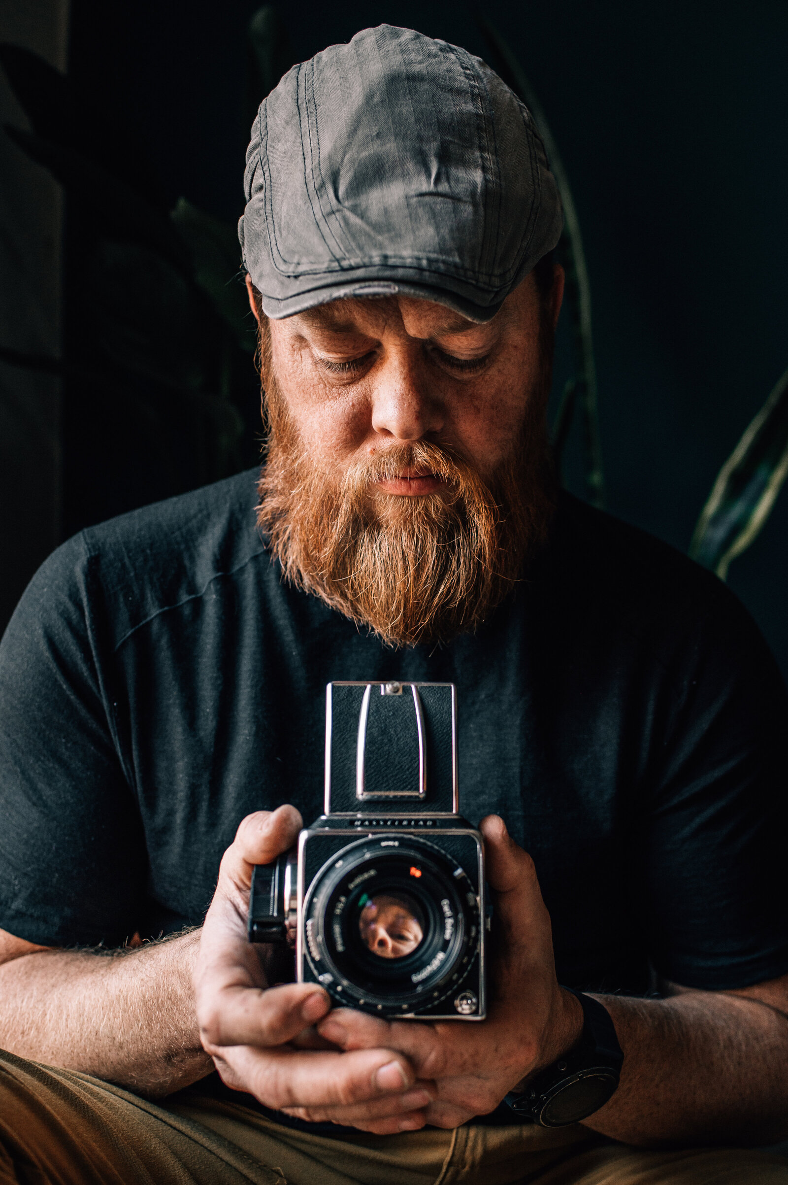 headshot of a man with an old camera brand story
