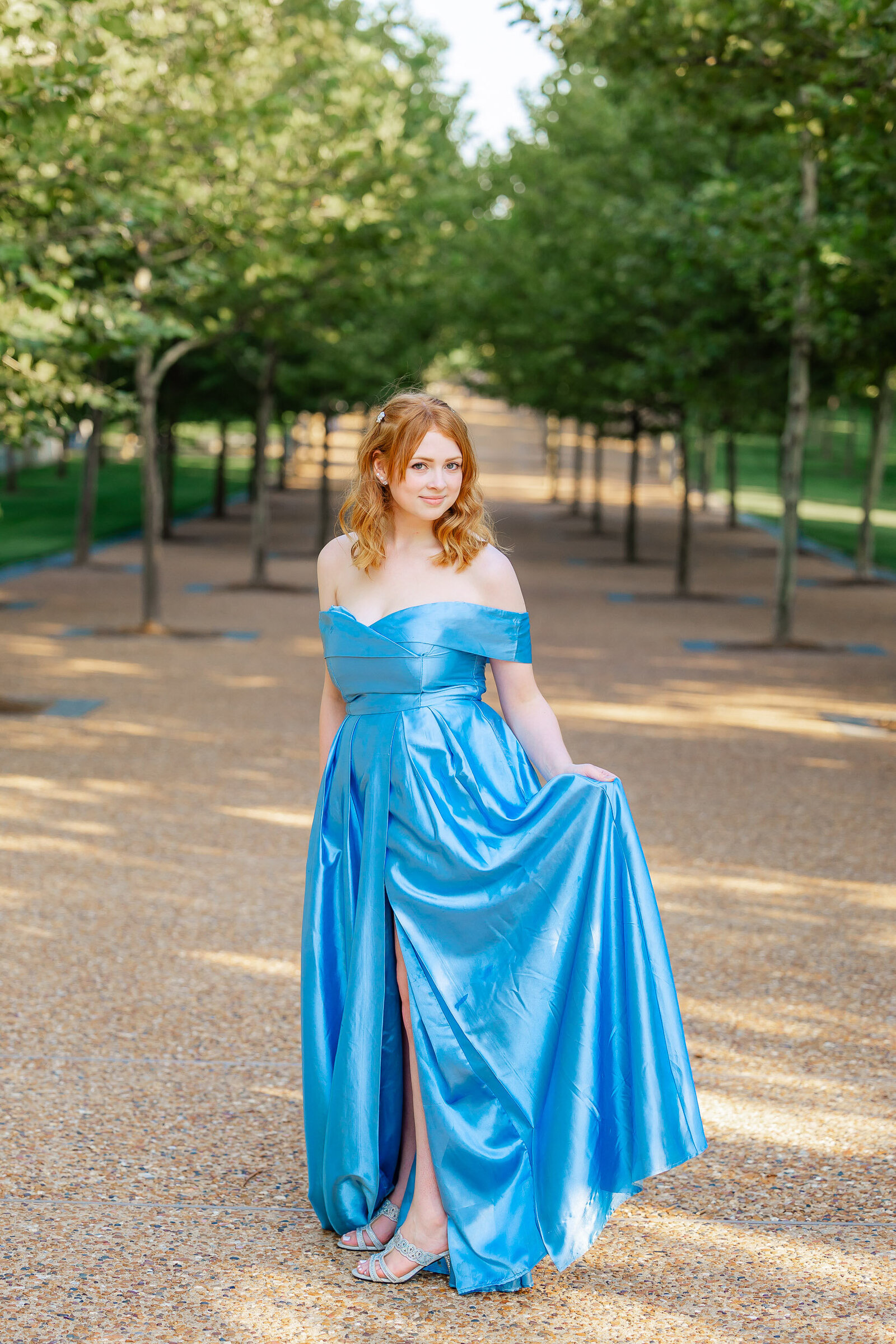 Ali in blue princess dress in Gateway Arch park