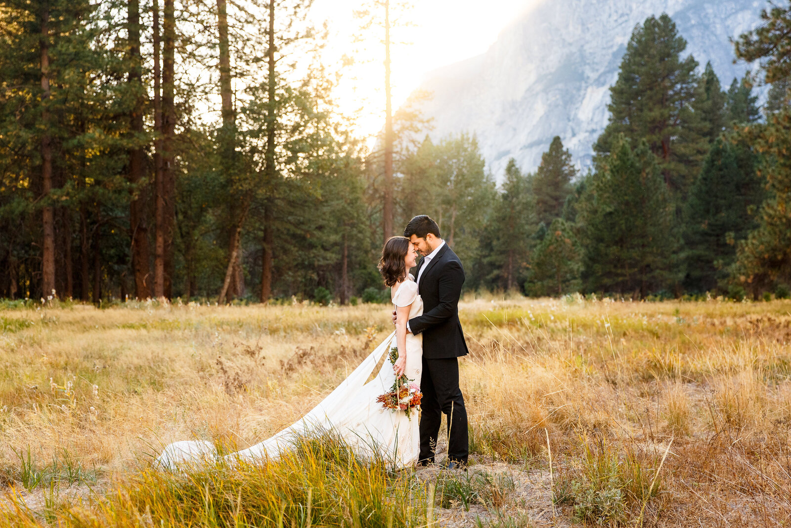 An eloping couple stares into each other's eyes at sunset in Yosemite.