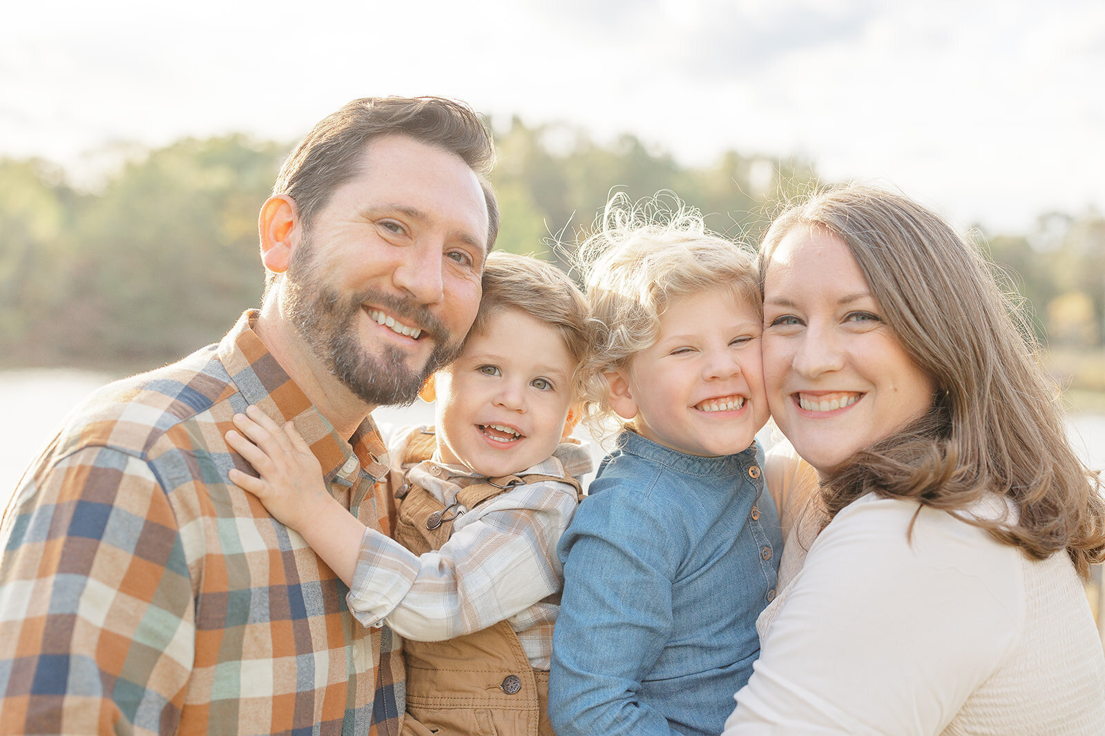family pose and smile during DMV family pictures