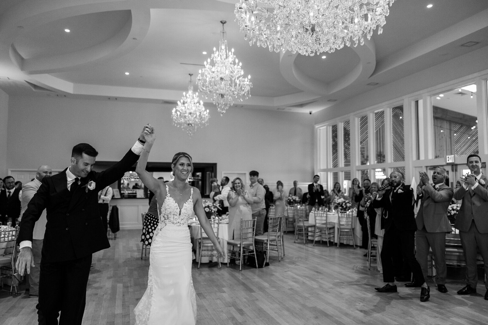 Bride and groom celebrating as they enter the reception at SkyView Golf Club