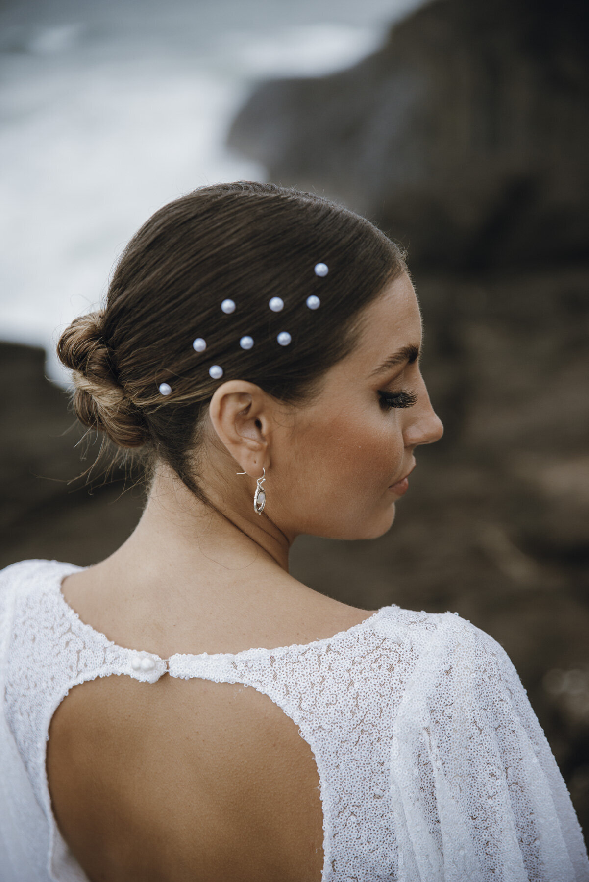 Bella Rae Bridal photo shoot with model Zo Chambers at the beach , looking beautul with a low twisted bun and Bridal Glam makeup captured by Holly K Photography