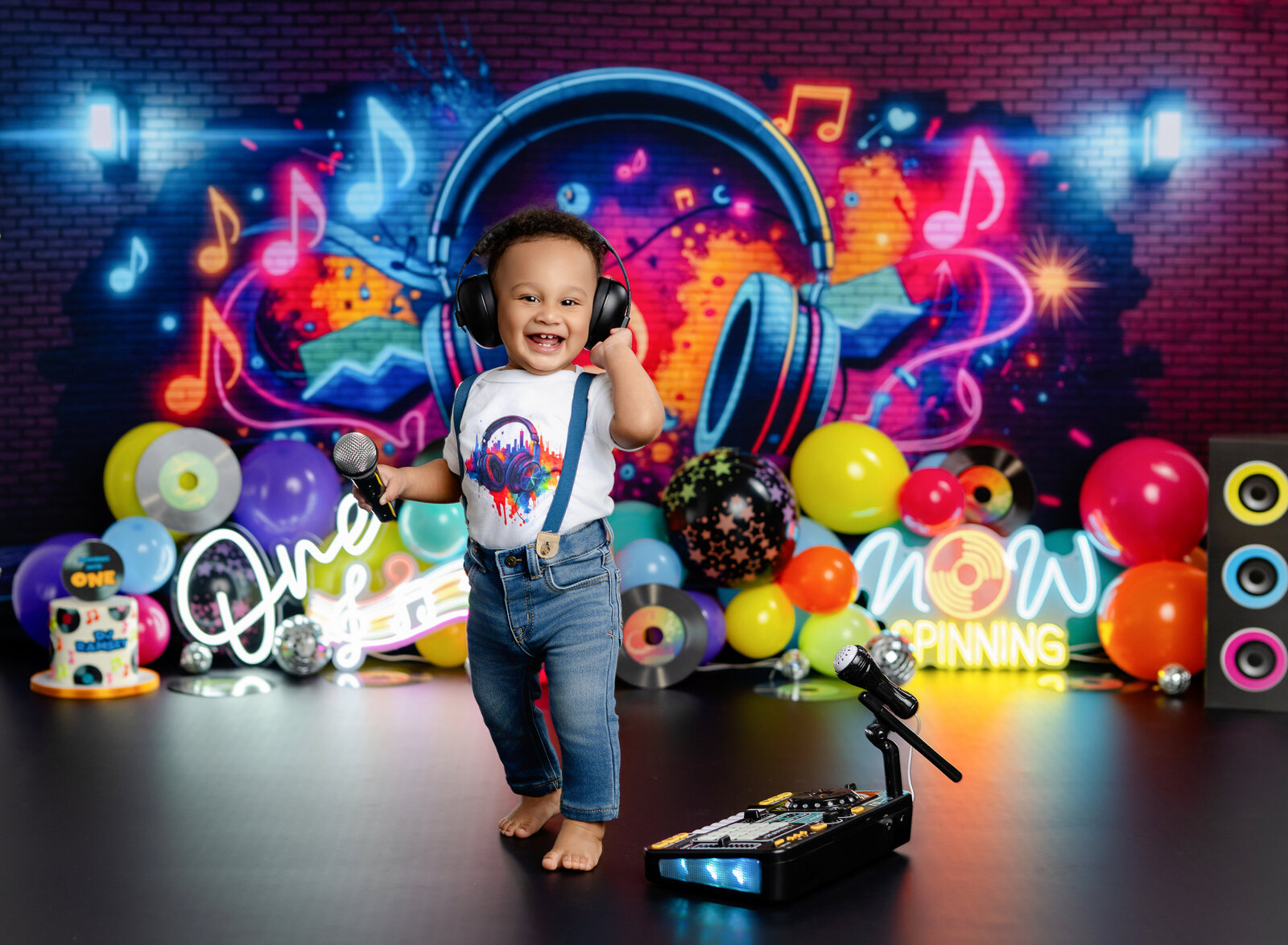 Baby with headphones on, listening to music on DJ birthday set. Photographed by Jenni Nikki Photography in Atlanta.