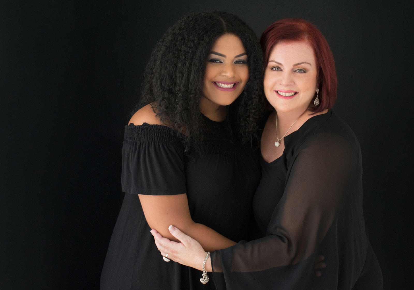 oakville mother and  daughter  hugging each other looking into camera wearing black dresses relationship goals