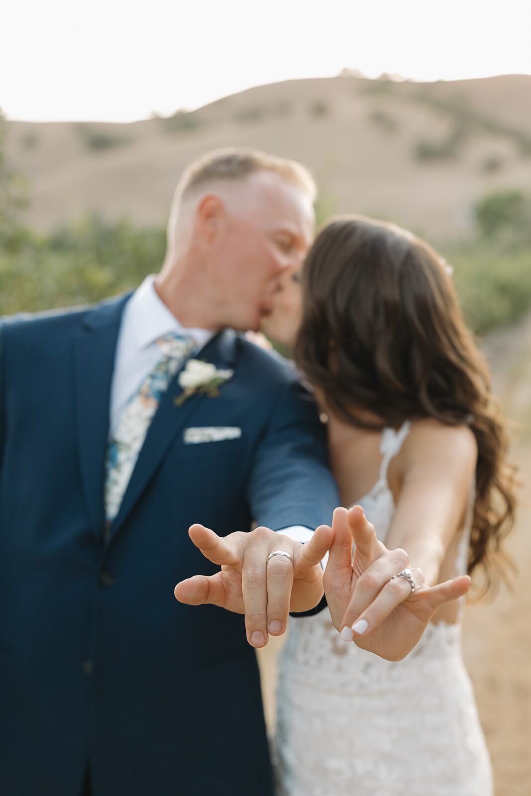 Bride and groom kissing and signing I love you