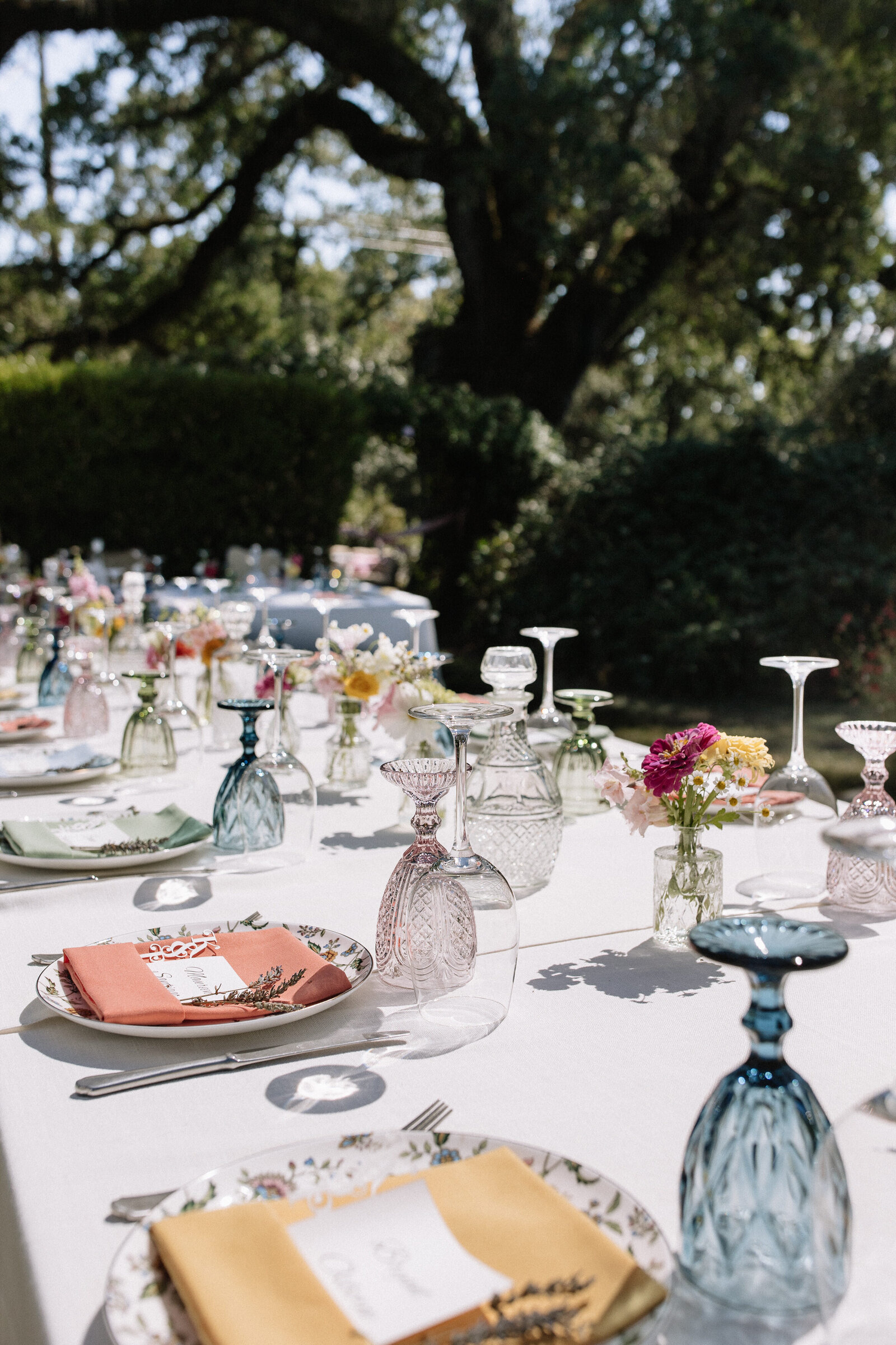 Outdoor garden wedding reception with colorful florals and vintage glasses in Idaho